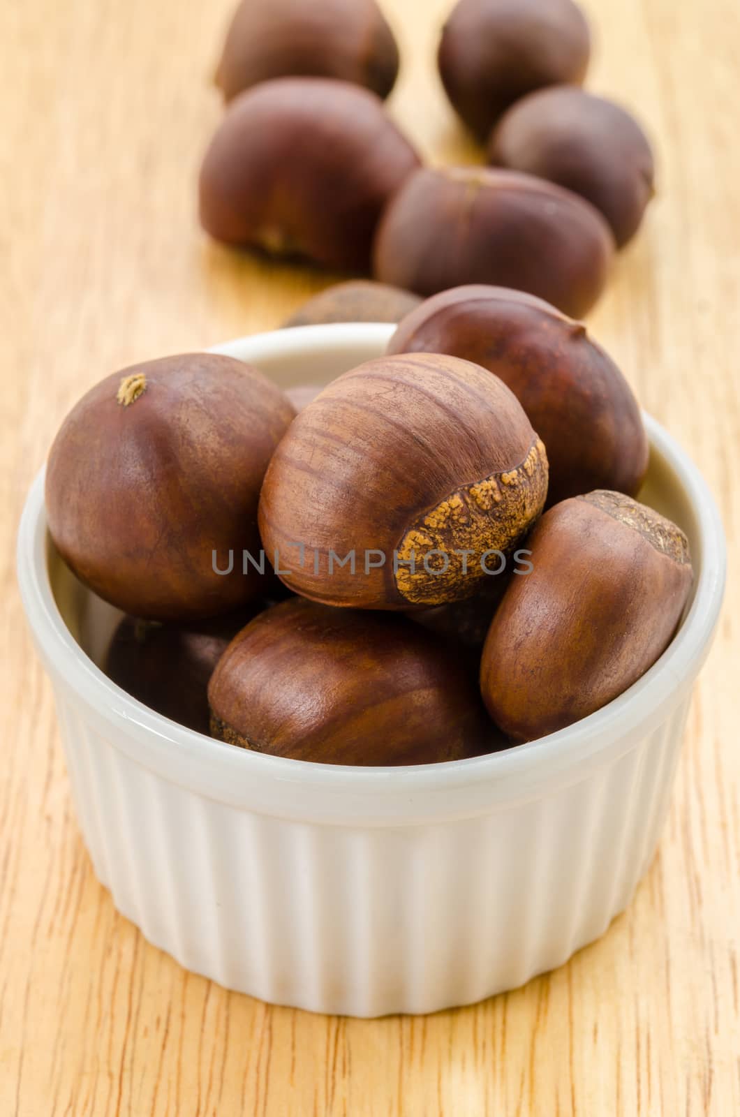 Many chestnut in white bowl on the table