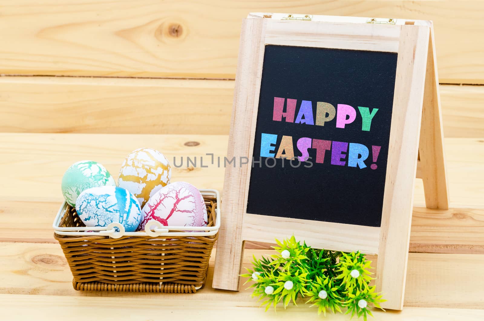 vintage easter decoration with eggs and flowers. chalkboard with sample text Happy Easter!