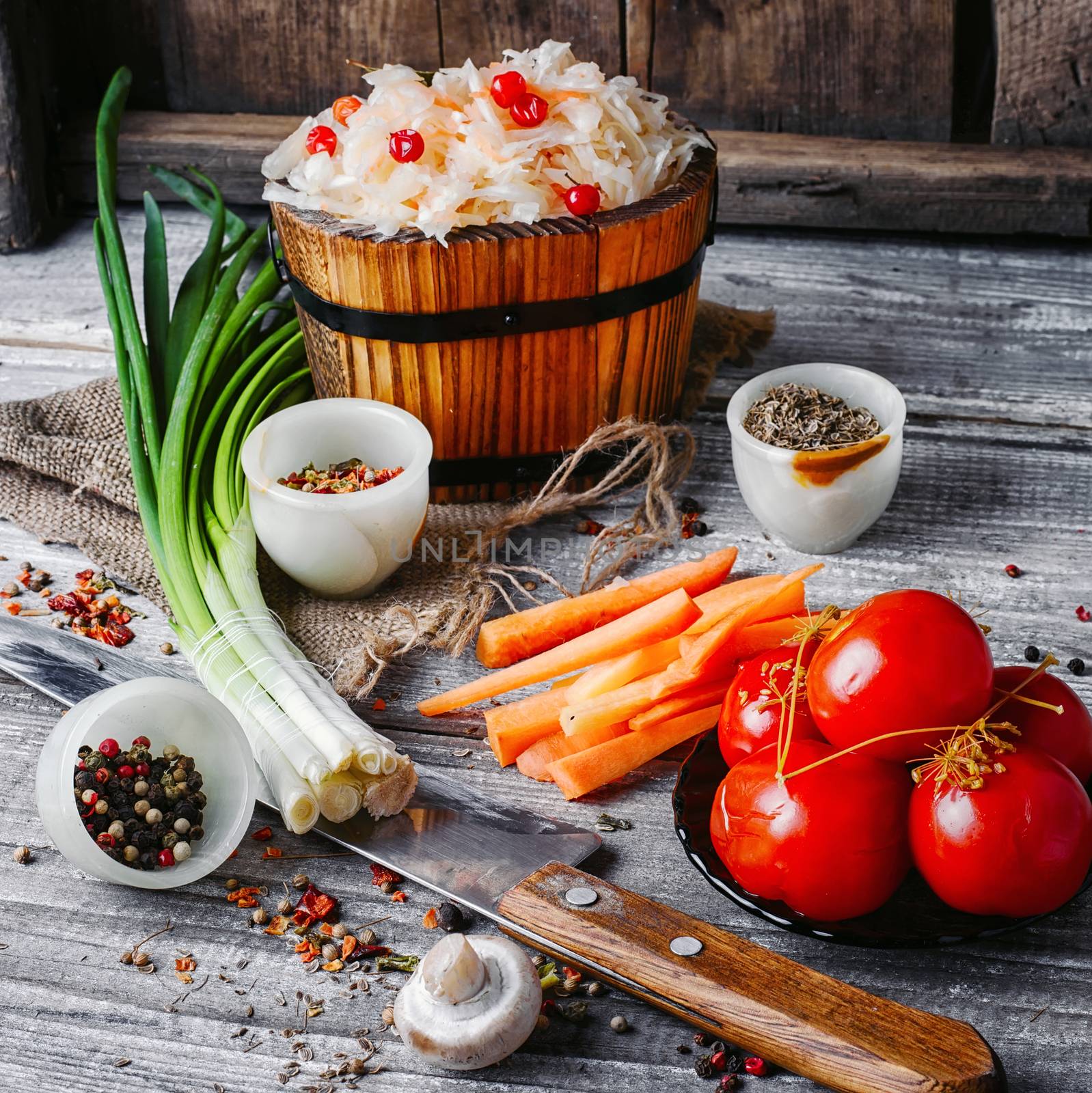 Set of pickled cabbage and salted tomatoes in a rustic style