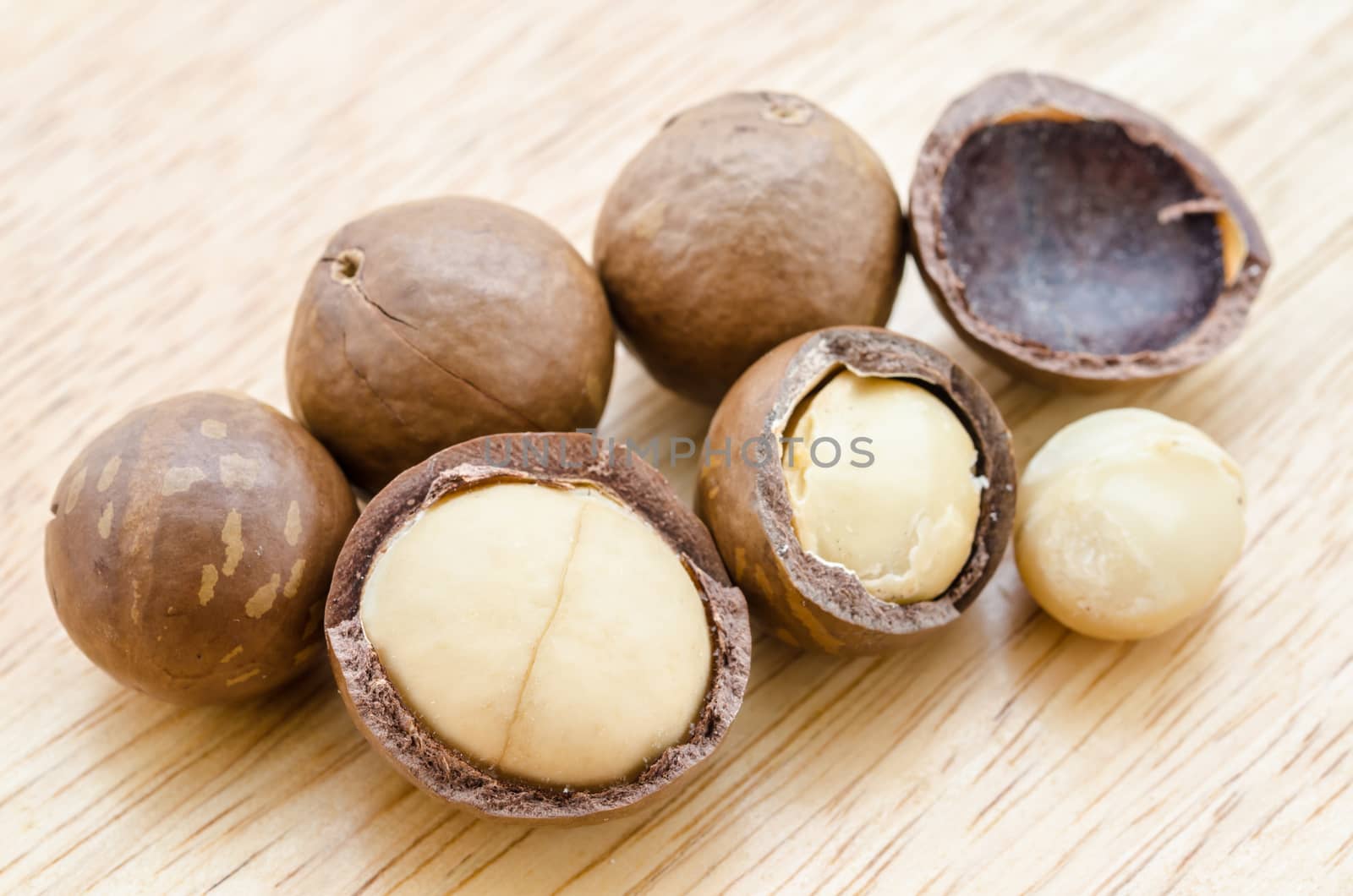 Macadamia nut on wooden background