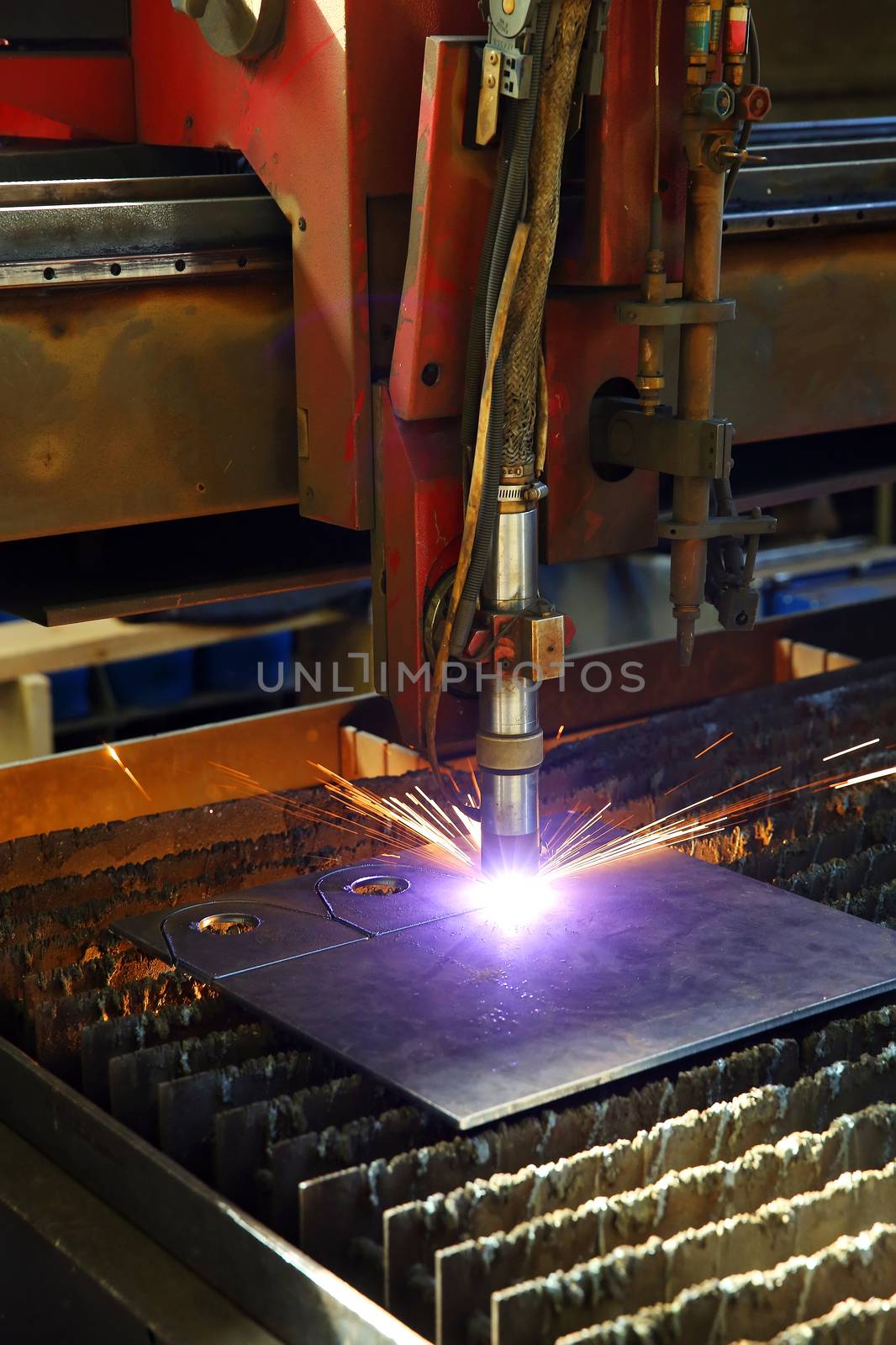 Industrial cnc plasma cutting of metal plate. Closeup by sergasx