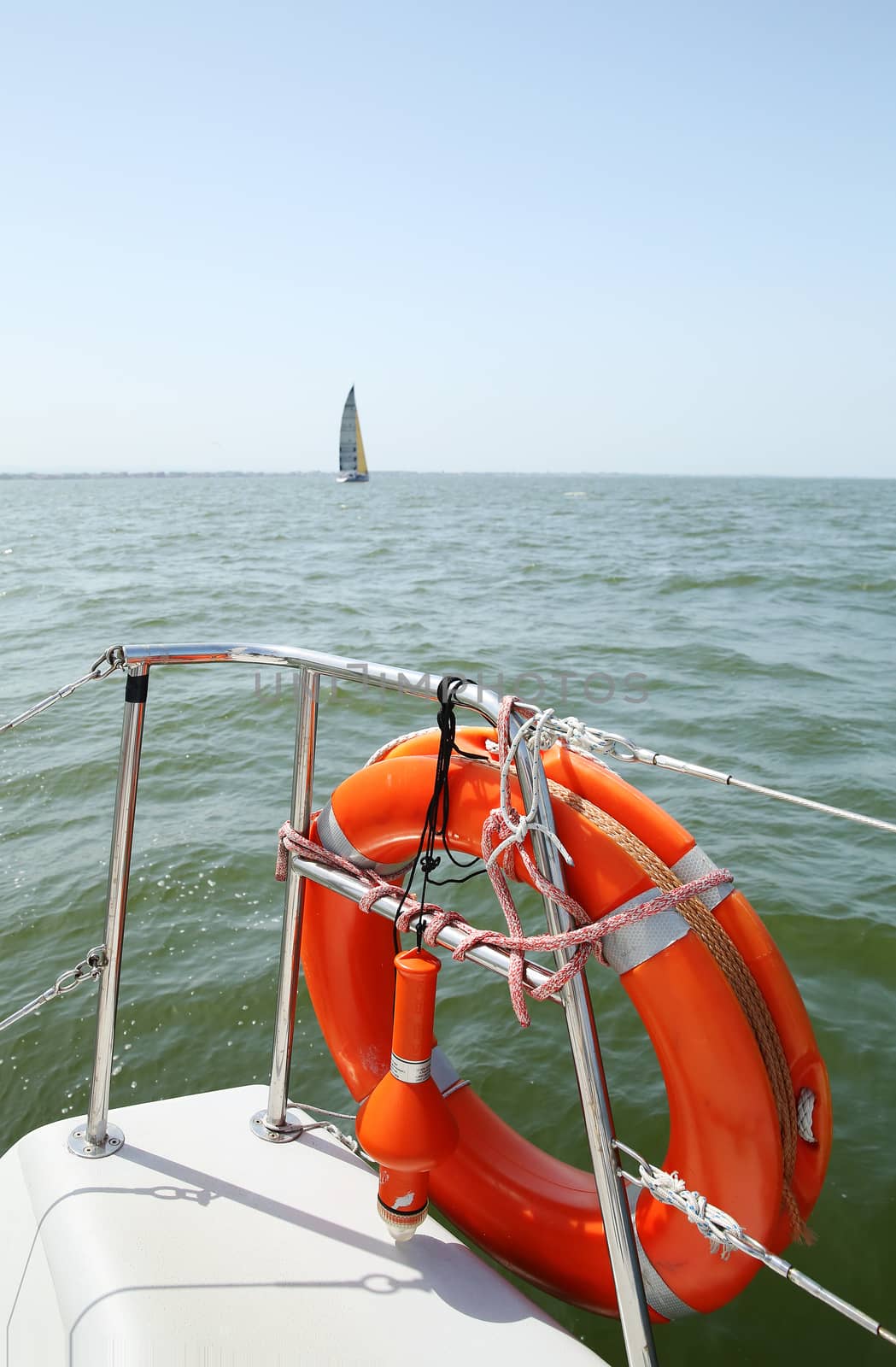 Lifebuoy on a yacht side. Concept of safe sea walk. by sergasx