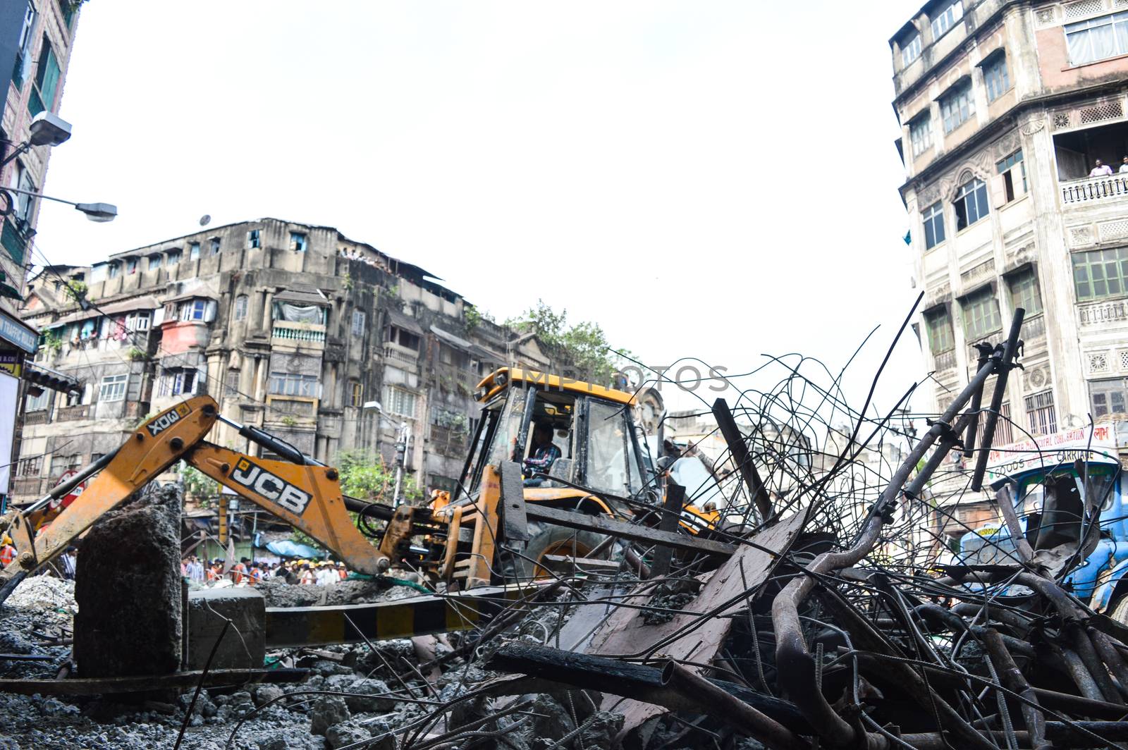 INDIA, Kolkata: Indian rescue workers clear away debris amid efforts to free people trapped under the wreckage of a collapsed flyover bridge in Kolkata on April 1, 2016. Emergency workers in India battled to rescue dozens of people still trapped after a flyover collapsed onto a busy street, killing at least 22 people and injuring over 100 more.