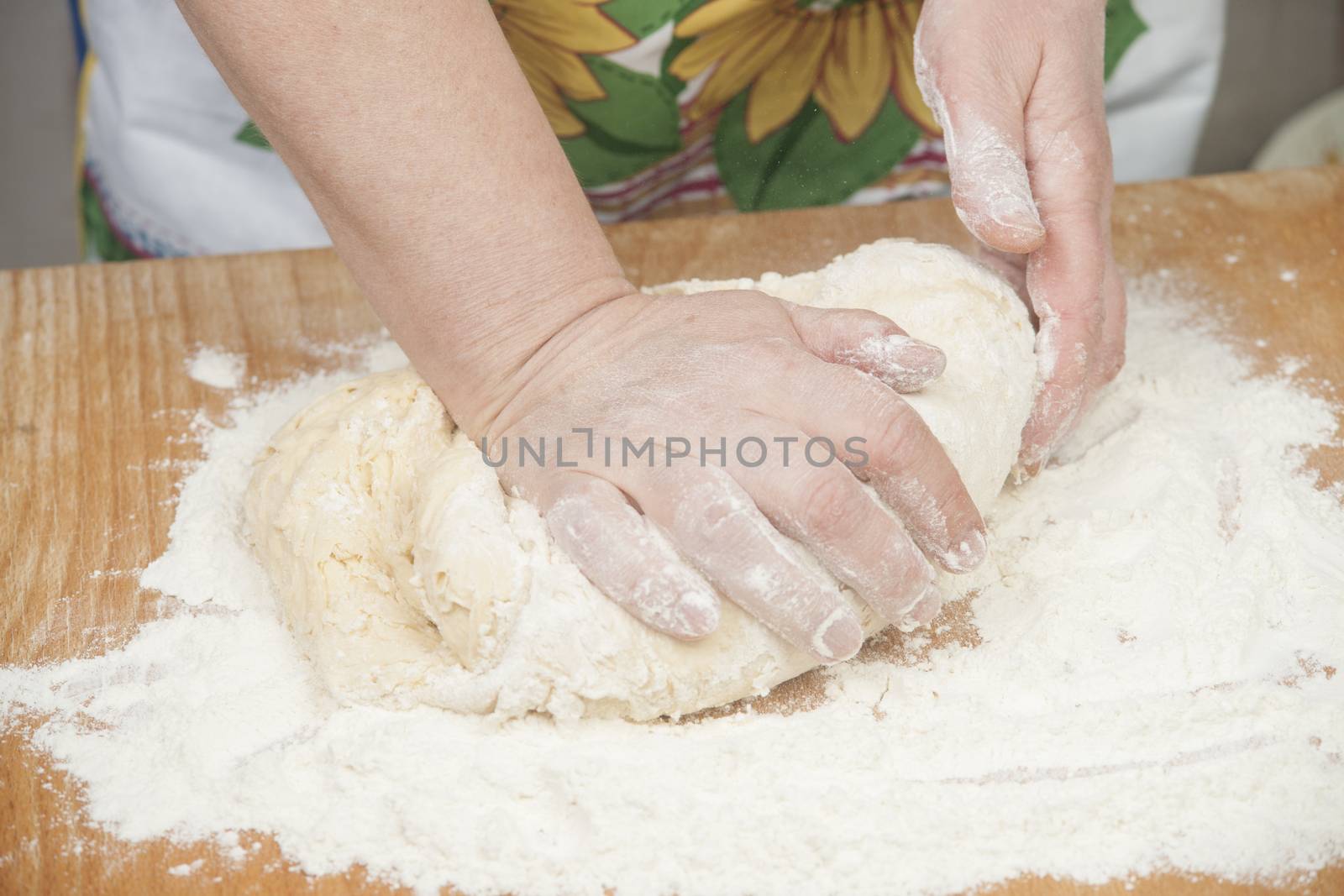 Women's hands preparing fresh yeast dough by kozak