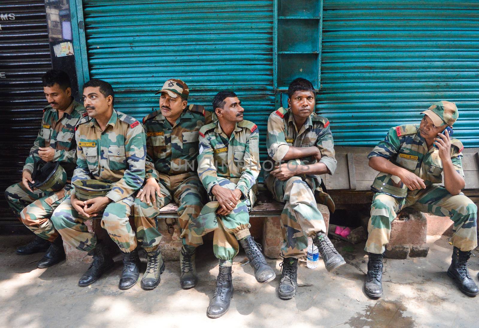 INDIA, Kolkata: Indian soldiers rest, as rescue operation goes on in order to free people trapped under the wreckage of a collapsed flyover bridge in Kolkata on April 1, 2016. Emergency workers in India battled to rescue dozens of people still trapped after a flyover collapsed onto a busy street, killing at least 22 people and injuring over 100 more.