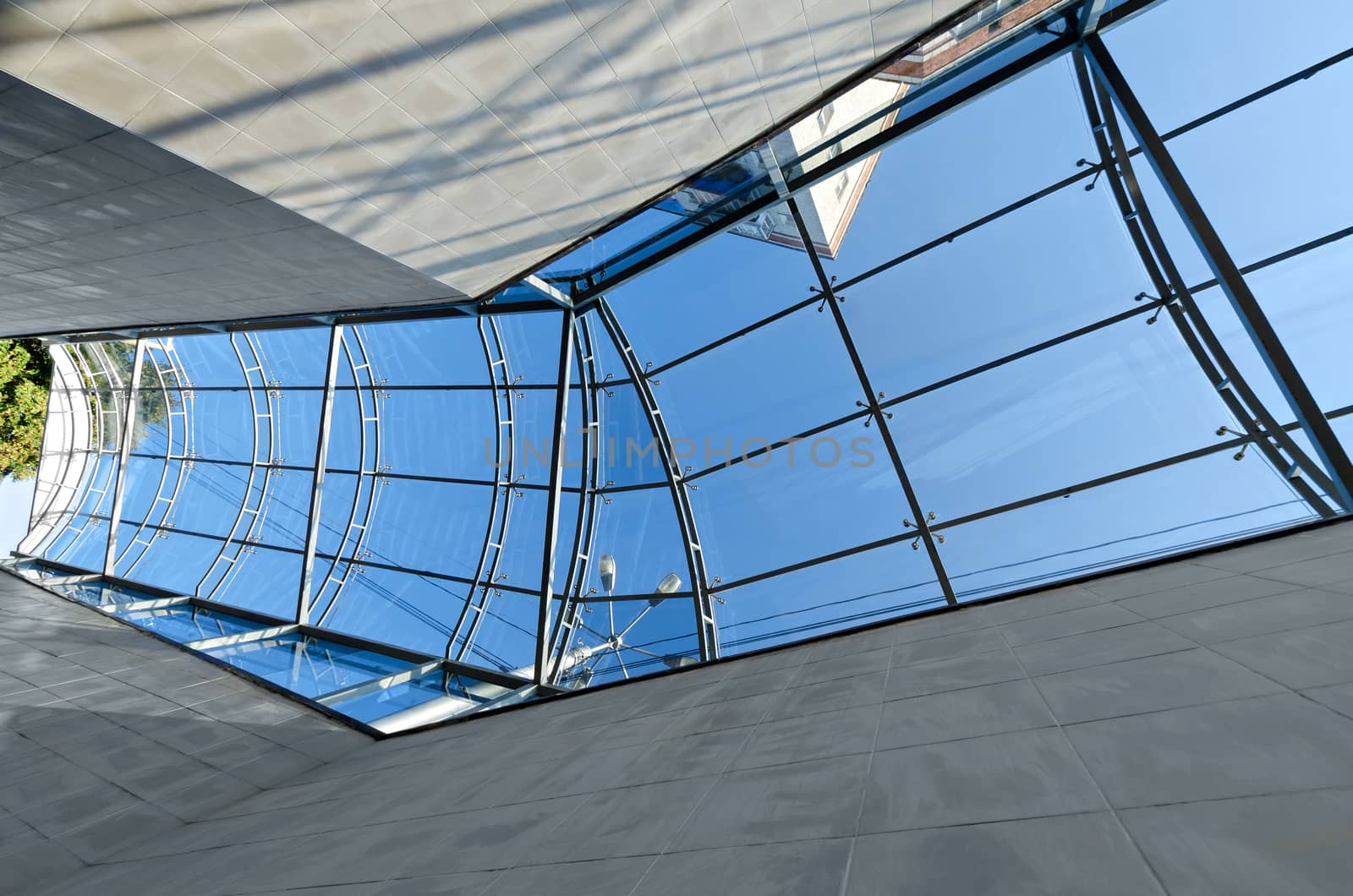 The glass roof at the crosswalk, reflection and blue sky