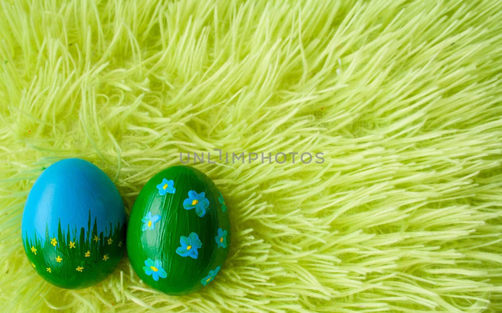 two Easter eggs on a green grass