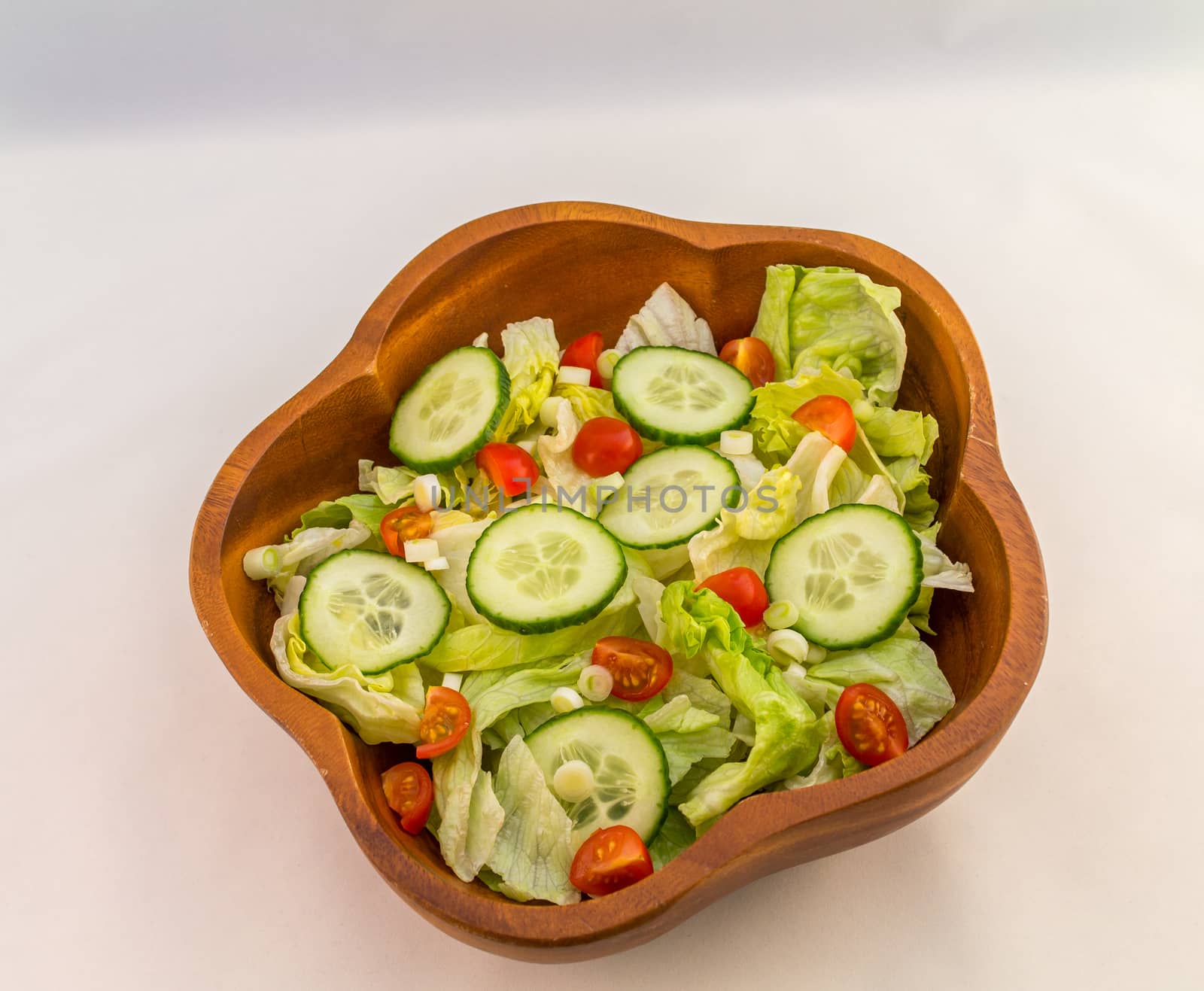 Bowl of mixed salad against a white background