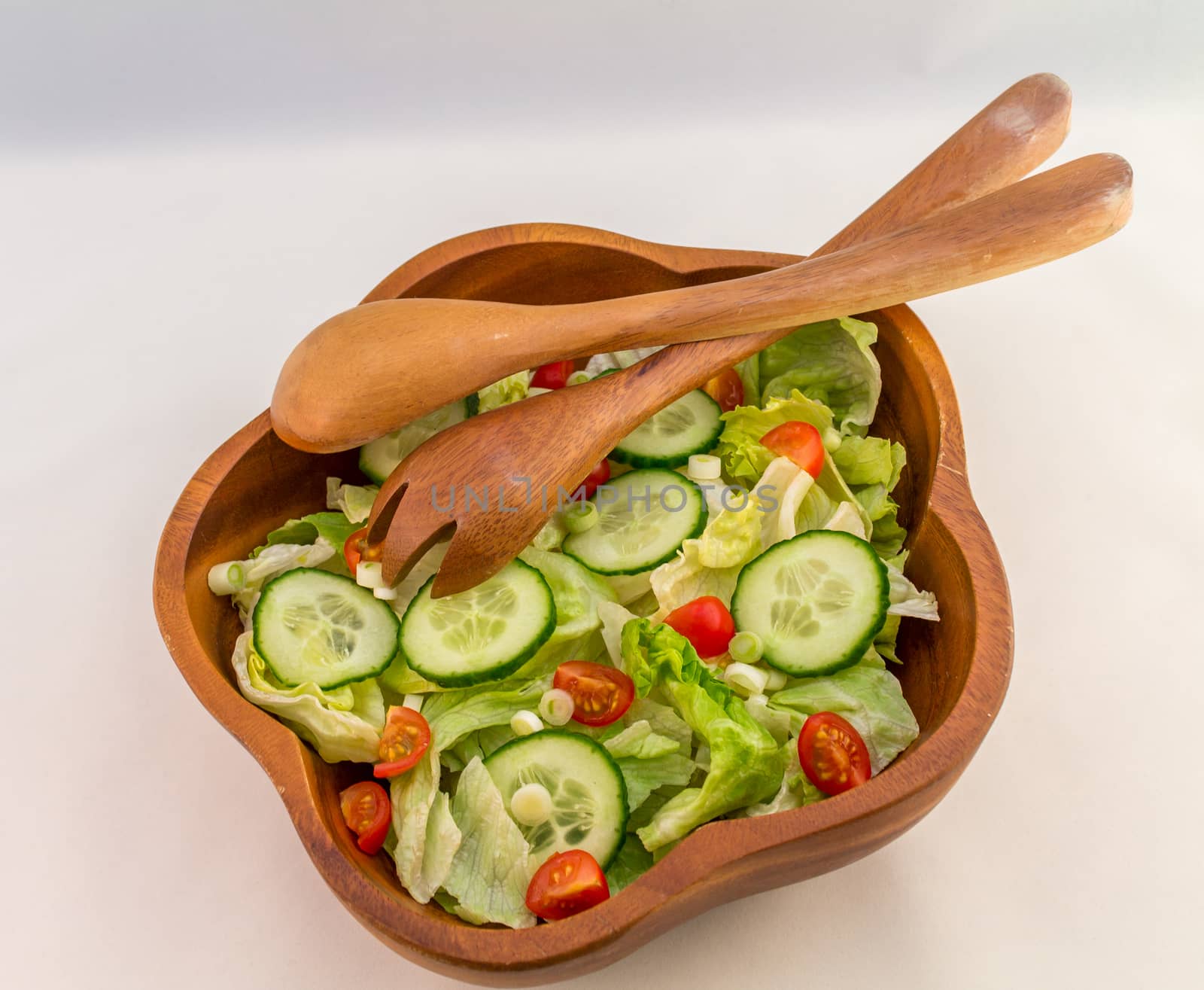 Bowl of mixed salad against a white background