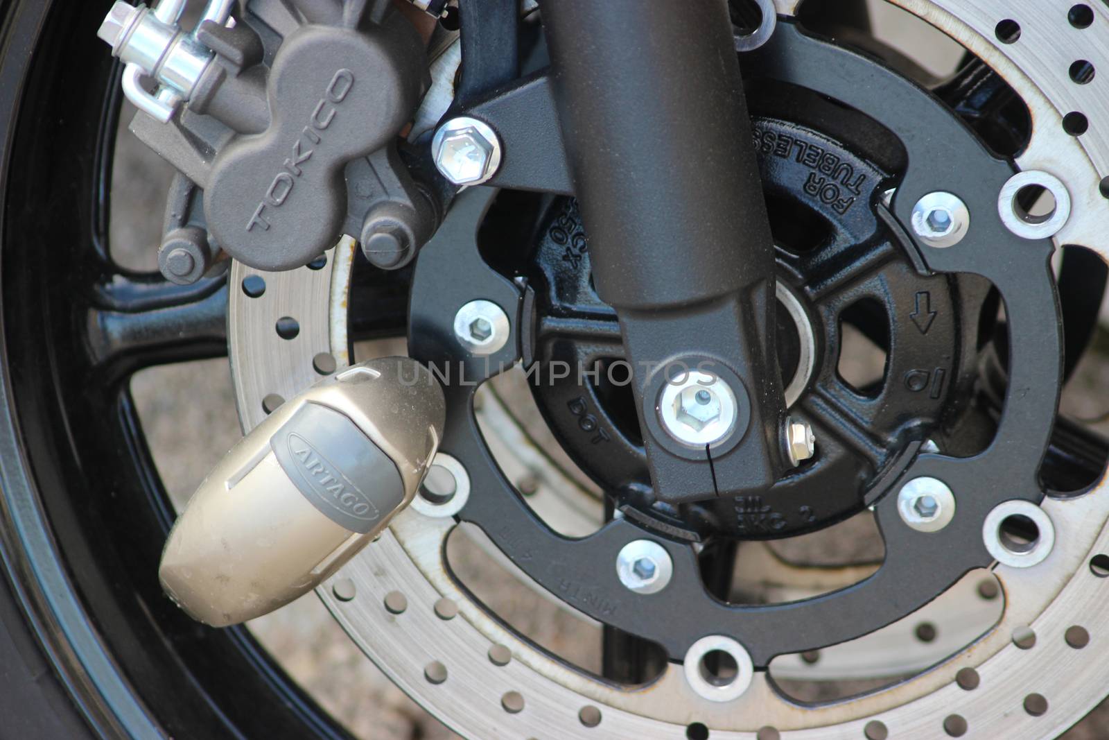 Nice, France - March 22, 2016: Yellow Disc Lock on Motorbike Disc Brake (Close-up)