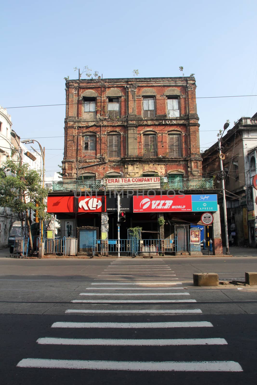 An aging, decaying, ex-colonial tenement block with shops in Kolkata, West Bengal, India