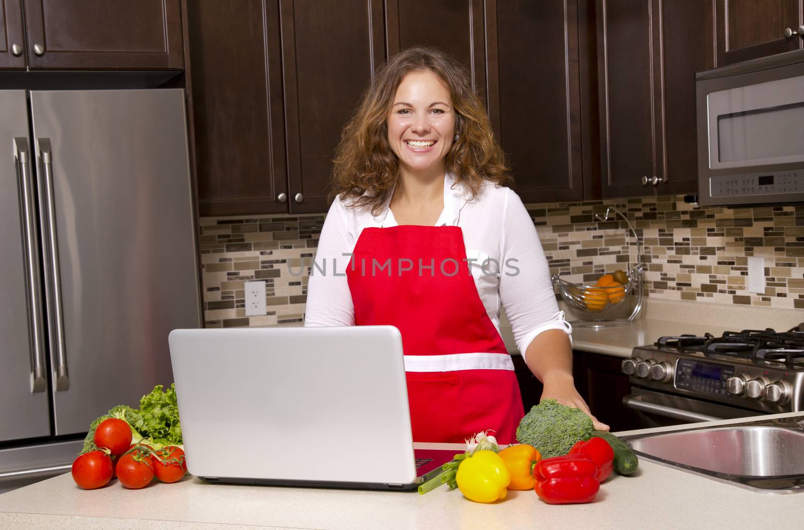 woman searching recipes online while cooking raw vegetables