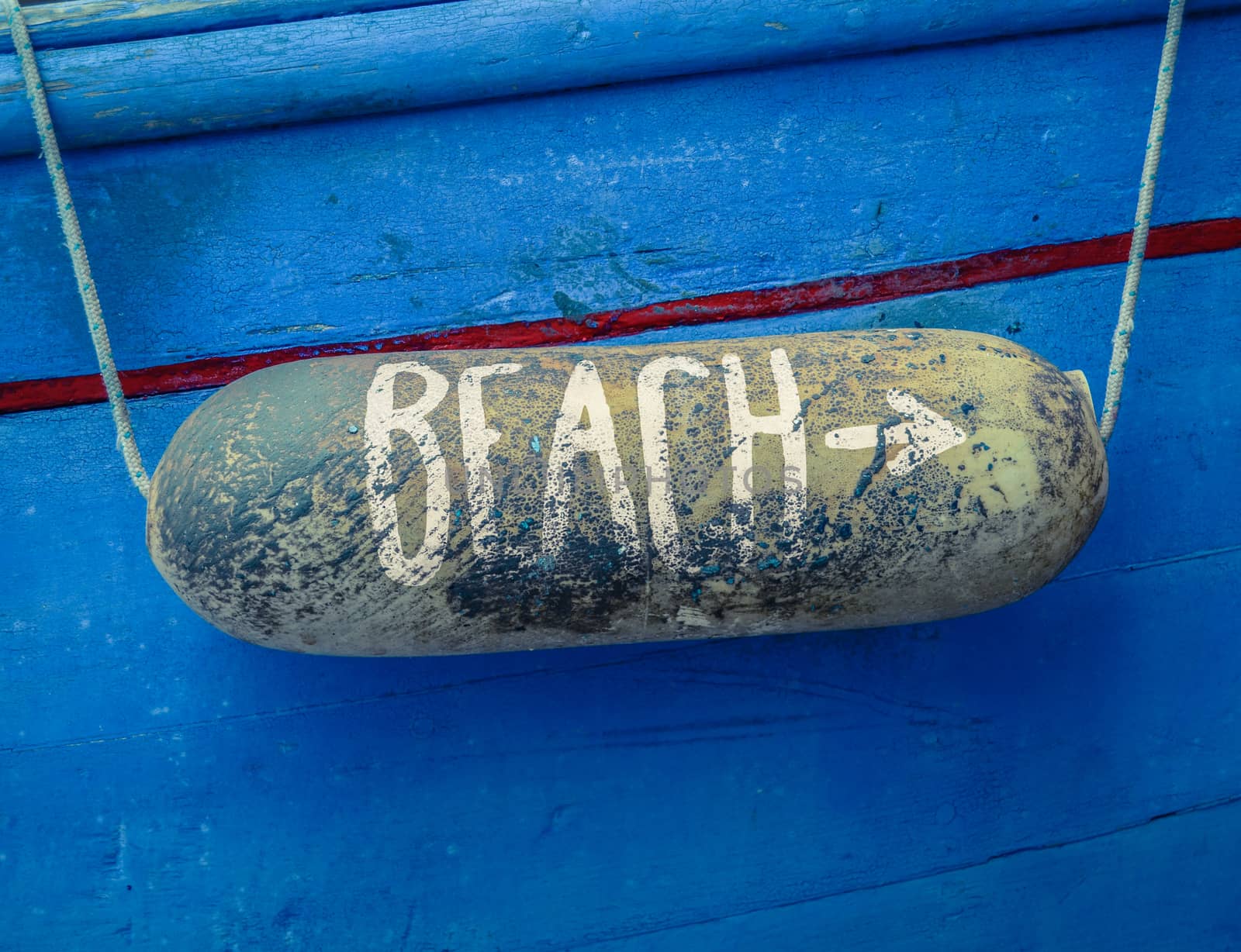 Retro Rustic Sign For A Beach On A Buoy On Of An Old Blue Boat