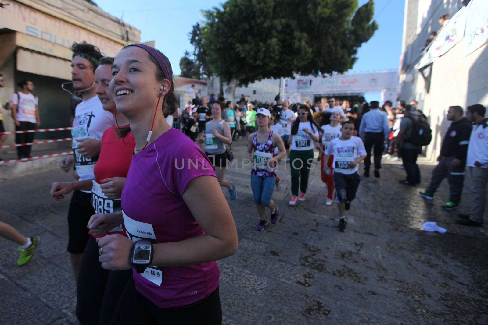 WEST BANK, Bethlehem: Women run through Bethlehem during the 4th annual Palestine Marathon on April 1, 2016.Runners from 64 countries ran through Bethlehem under the banner of the right to freedom of movement. Organizers said that more than 4,000 people registered for the event.