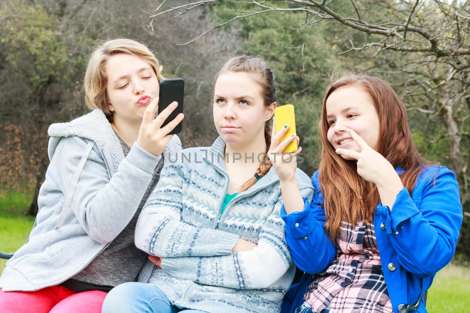 Two Cute Girls Doing Selfies With One Alone