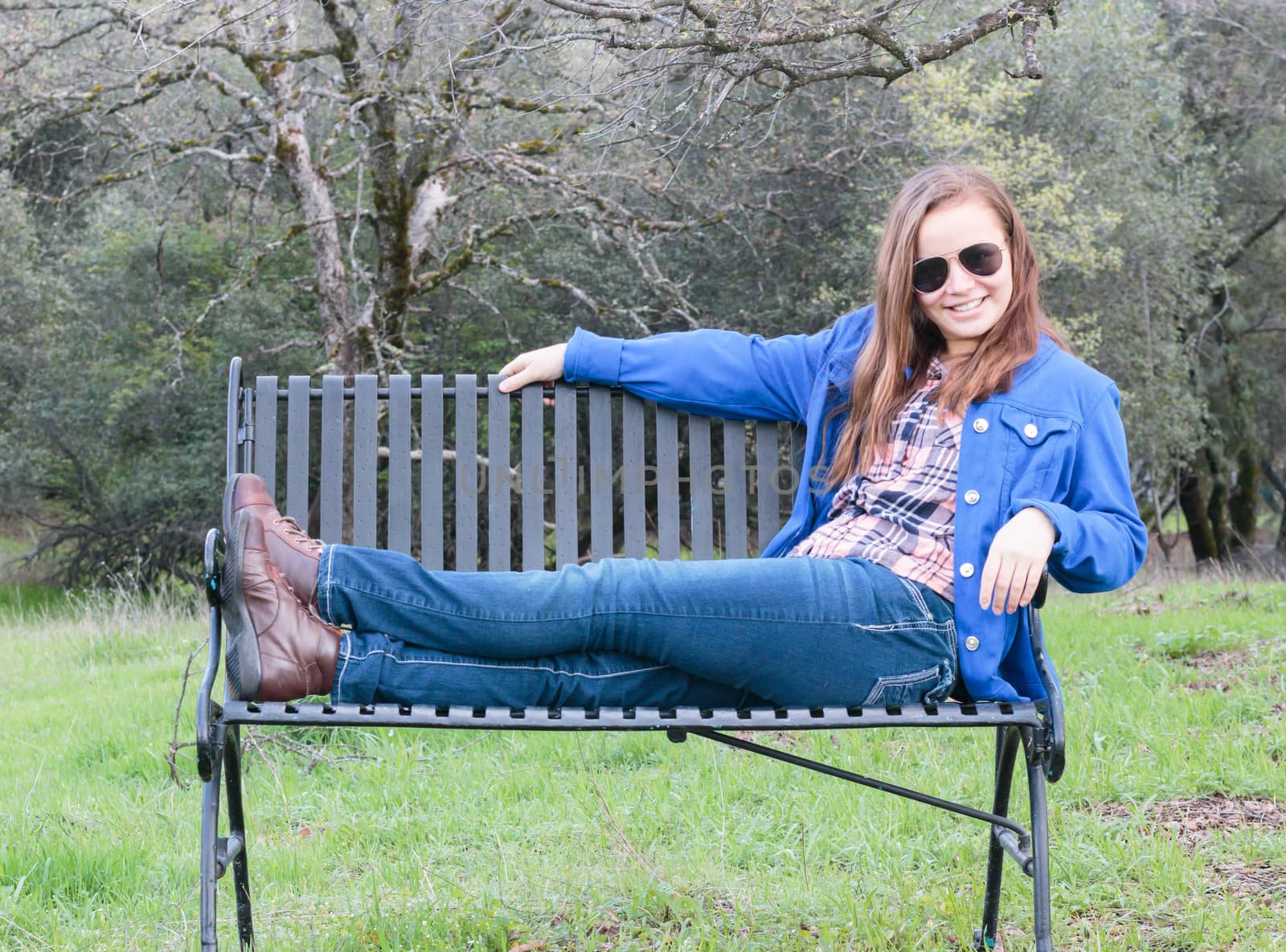 Young Teenage Girl Sitting on Park Bench