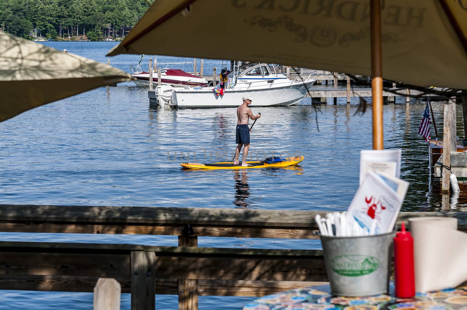 Man paddle on the ocean  by edella