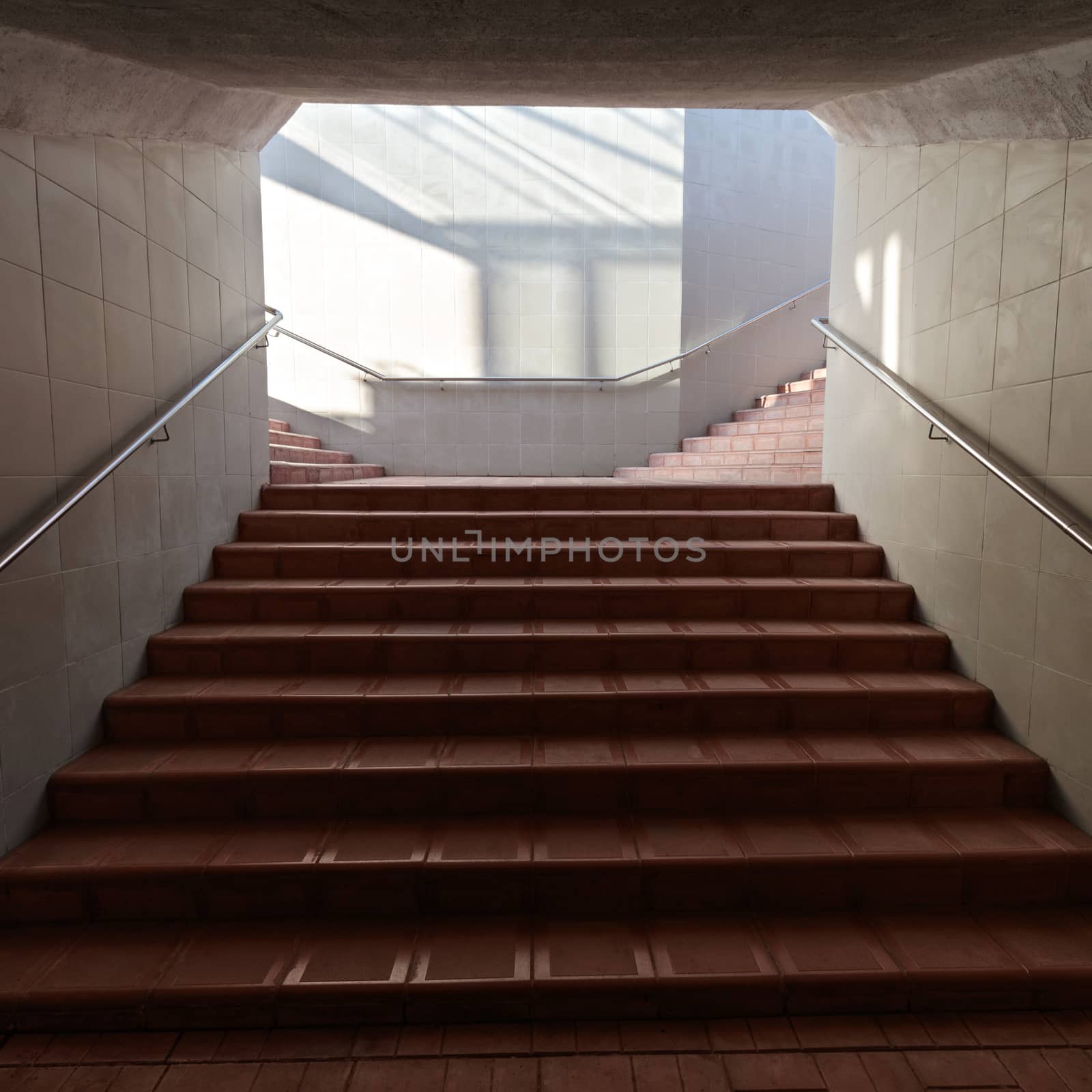 Climbing stairs, light in the underpass, there are no people.