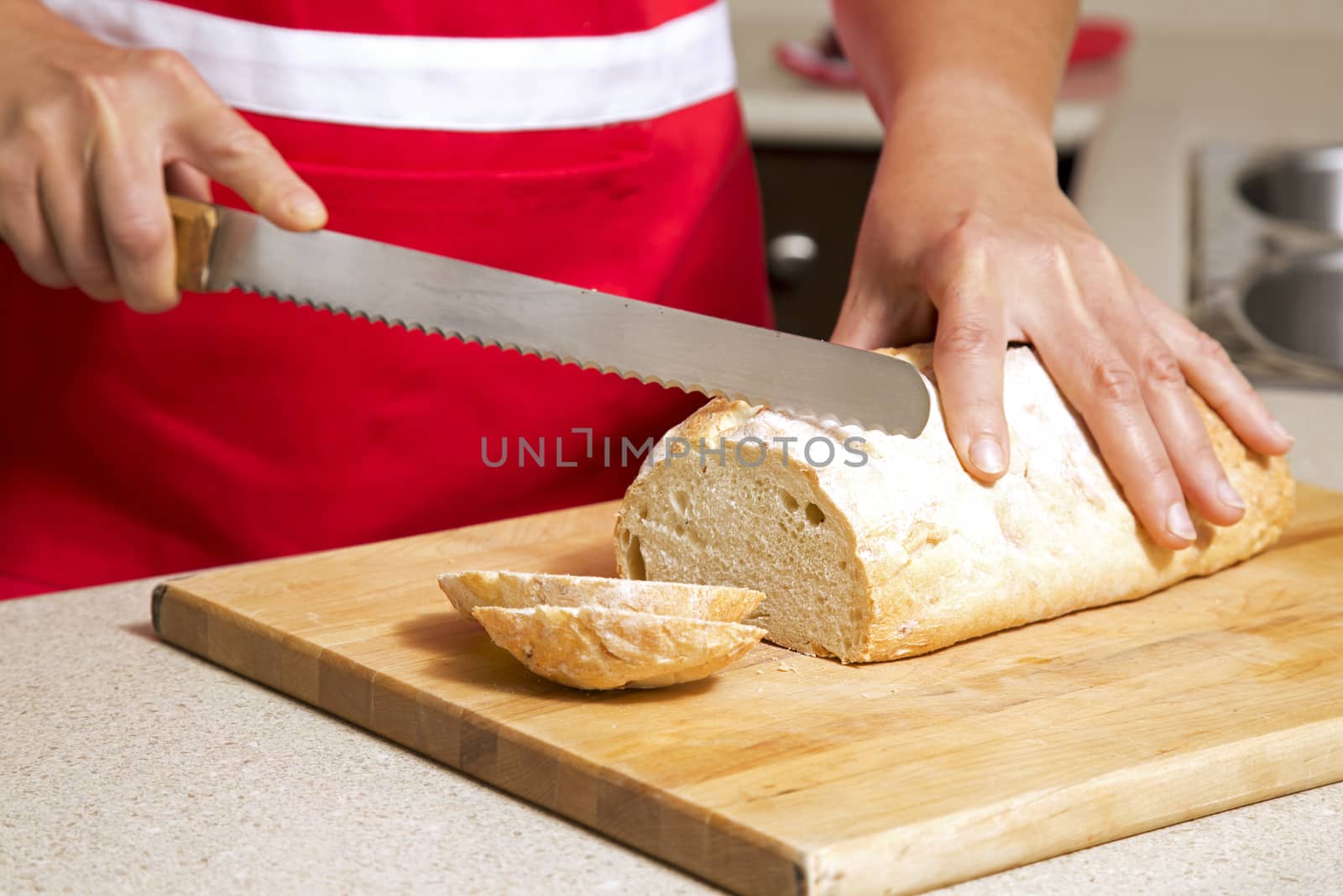 woman cutting bread by zdenkadarula