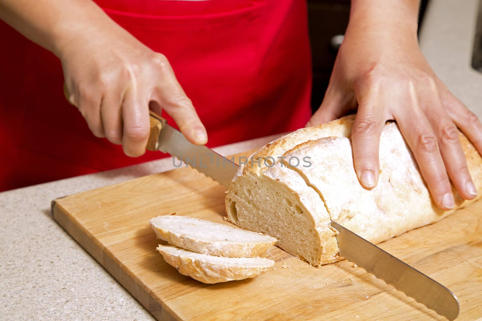 woman cutting bread by zdenkadarula