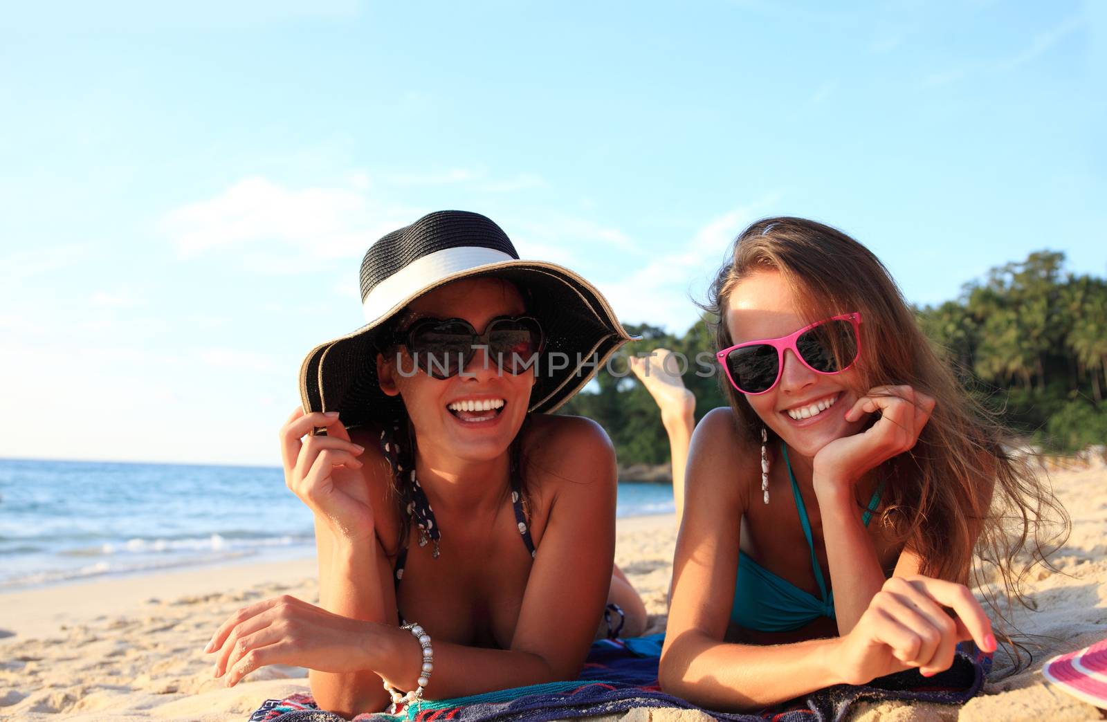 Female friends on beach by ALotOfPeople