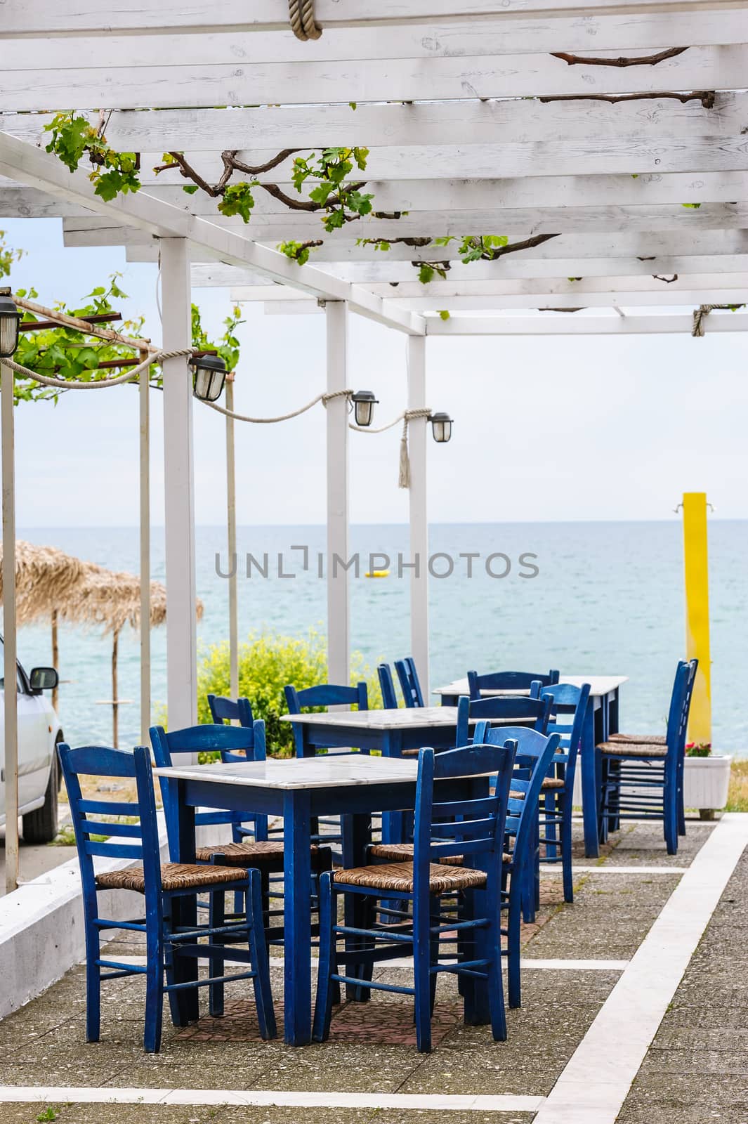 Empty mediterranean outdoor beach cafe, focus on closest table