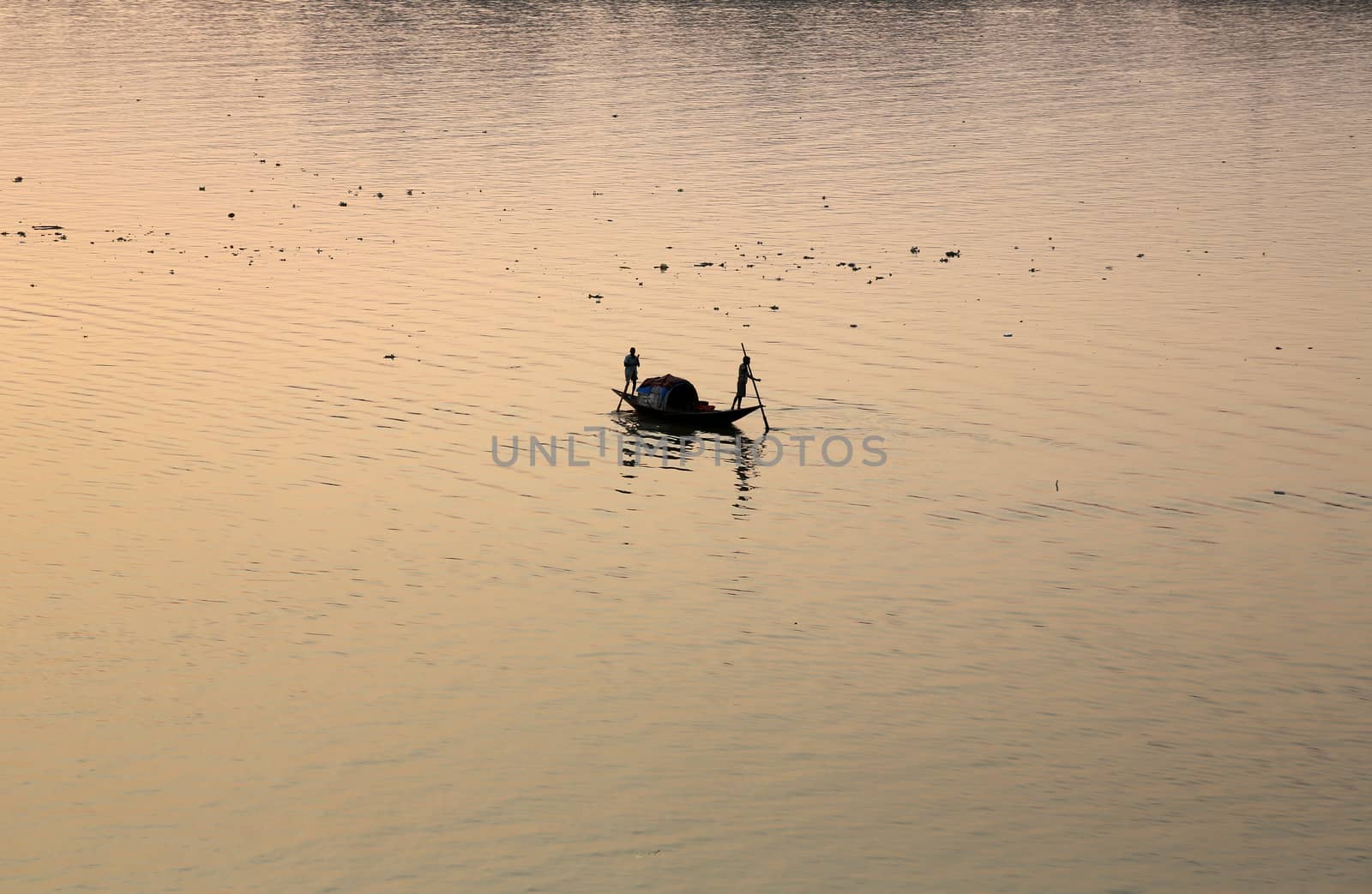 A boat crossing the Hoogly river in Kolkata during sunset