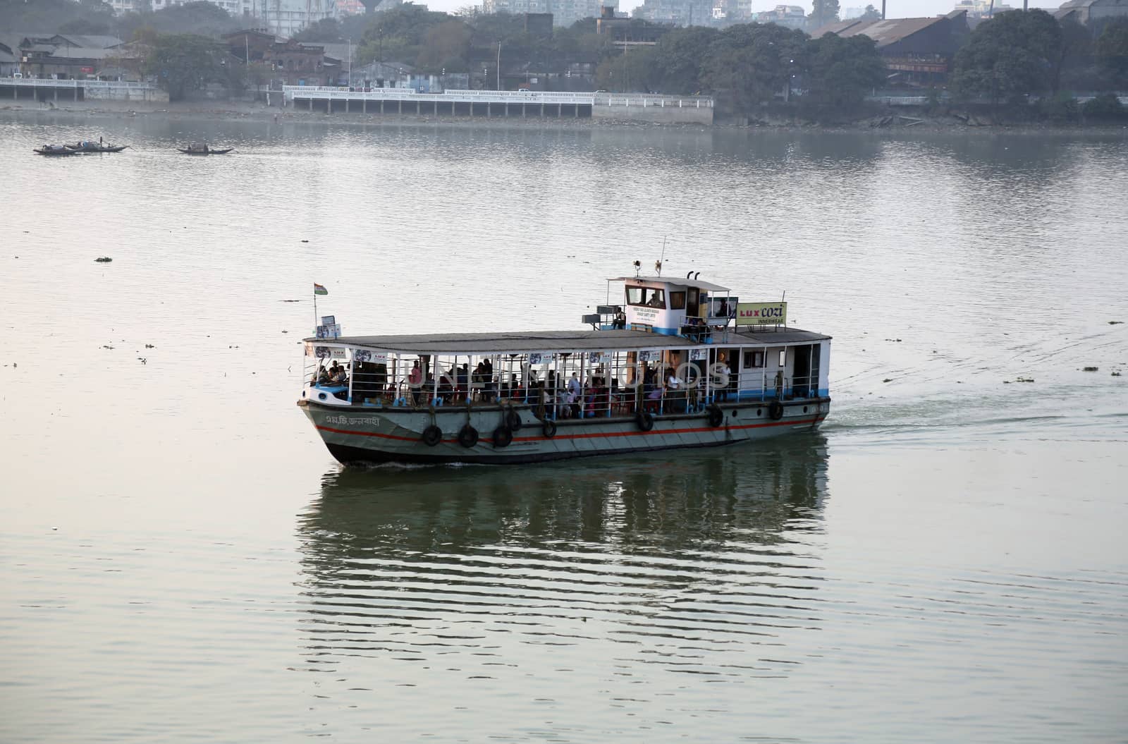 A boat crossing the Hoogly river in Kolkata during sunset
