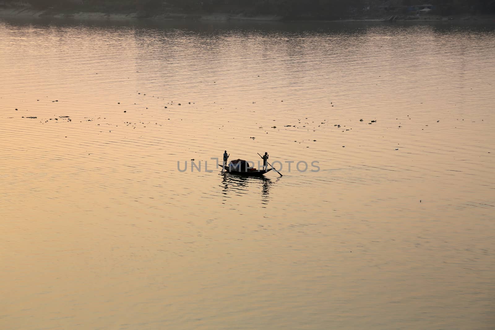 A boat crossing the Hoogly river in Kolkata during sunset