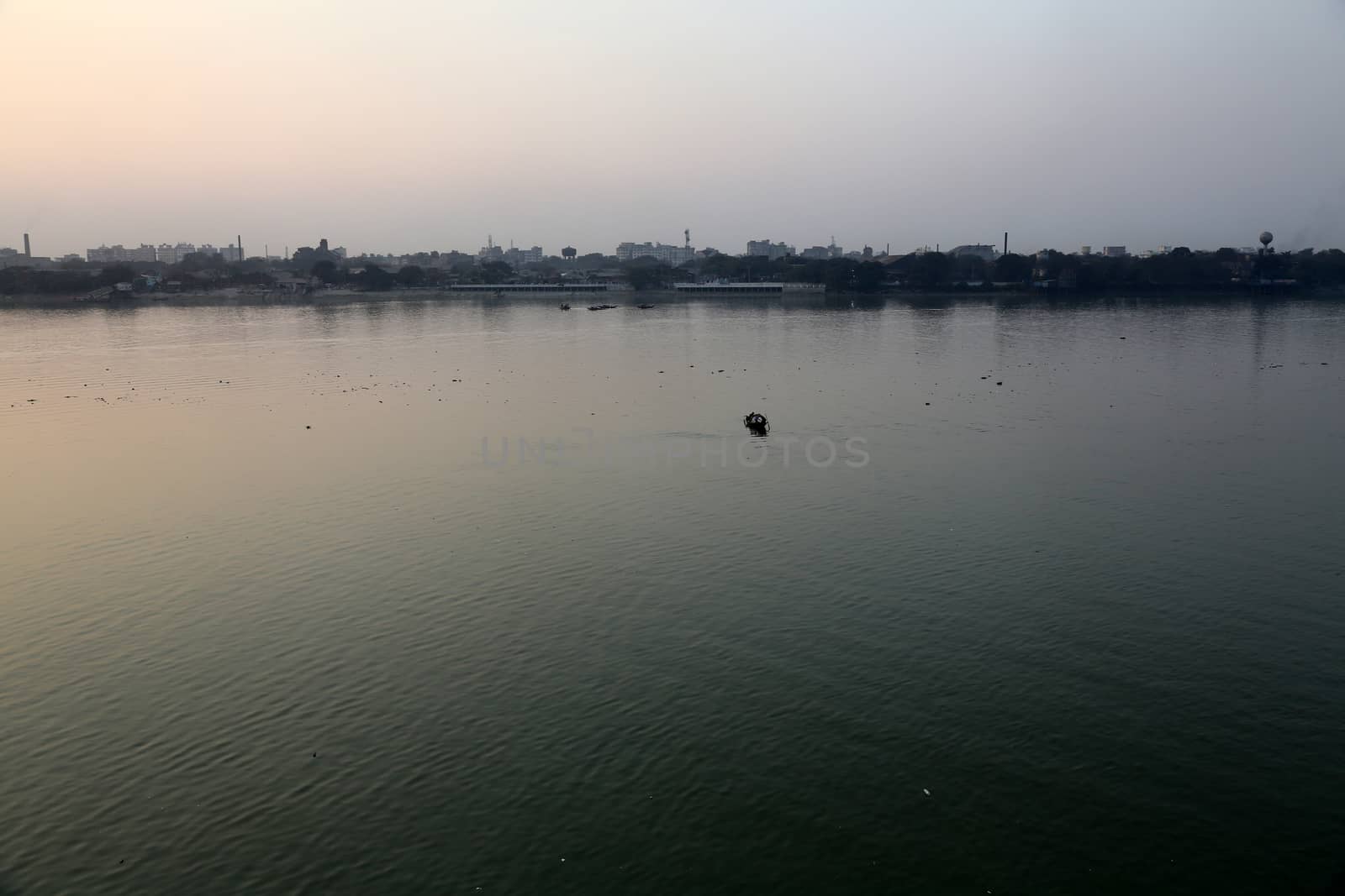 A boat crossing the Hoogly river in Kolkata during sunset