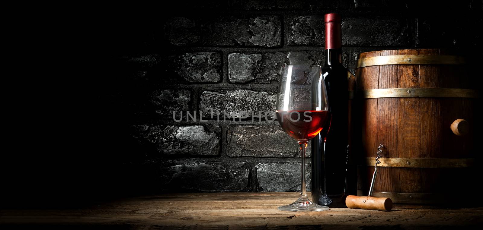 Old red wine near black brick wall