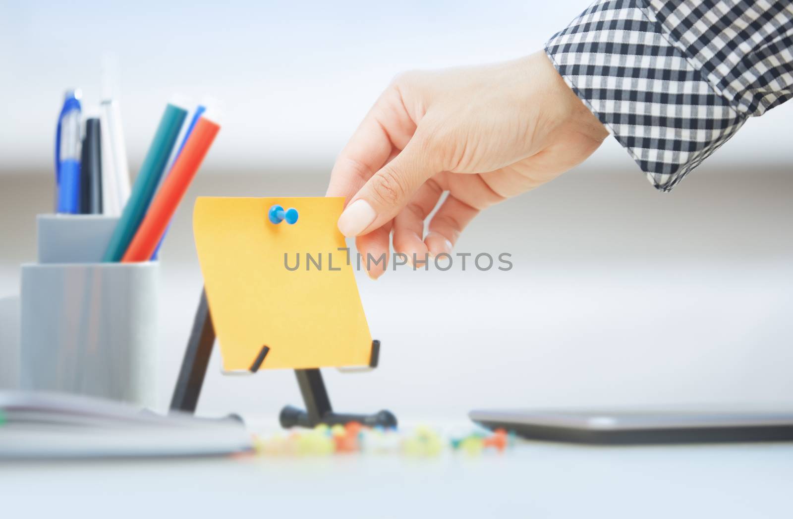 Human hand holding adhesive note with empty space