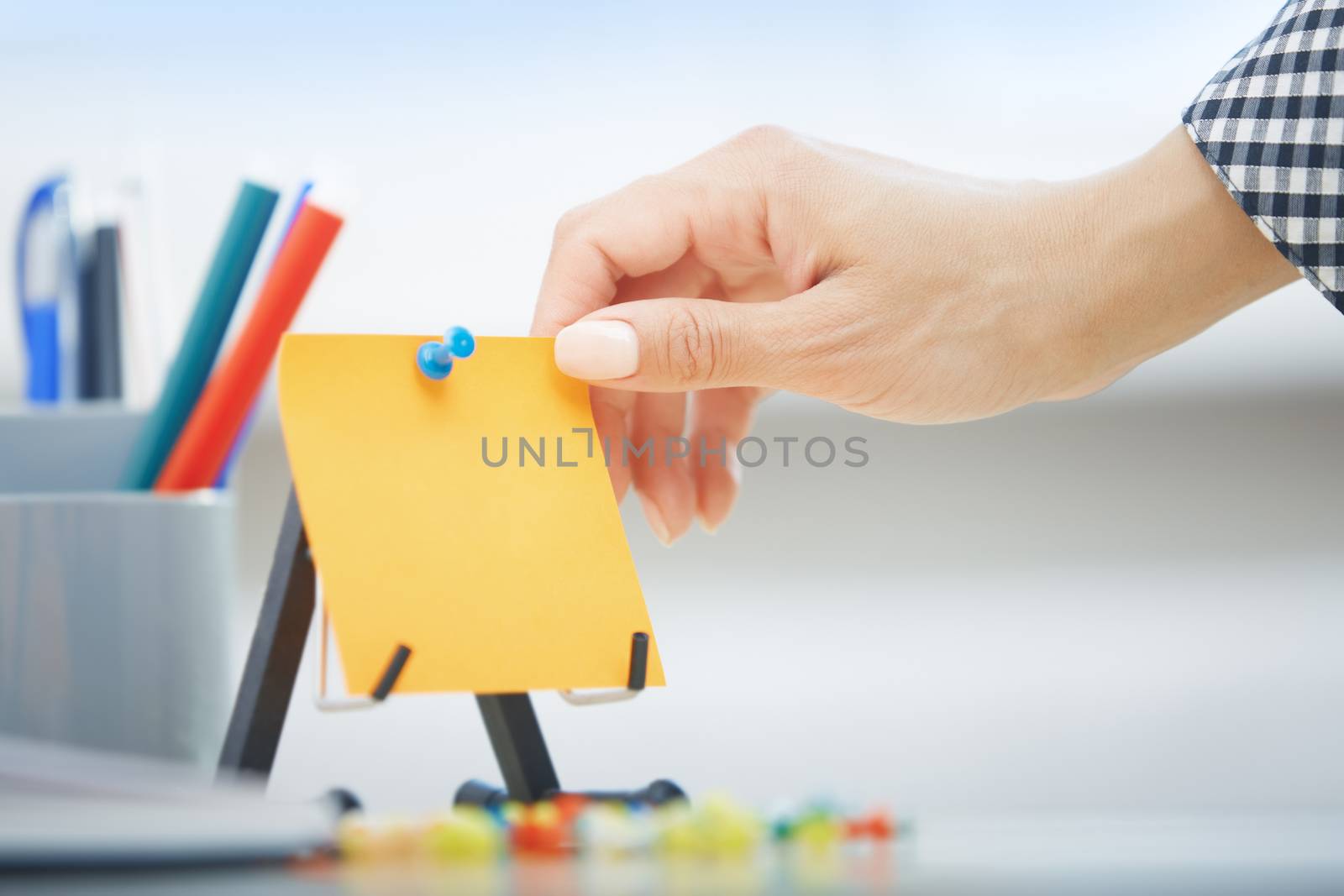 Human hand holding adhesive note with empty space