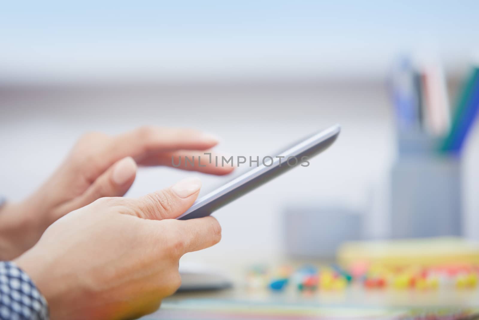 Hands of businessperson using digital tablet