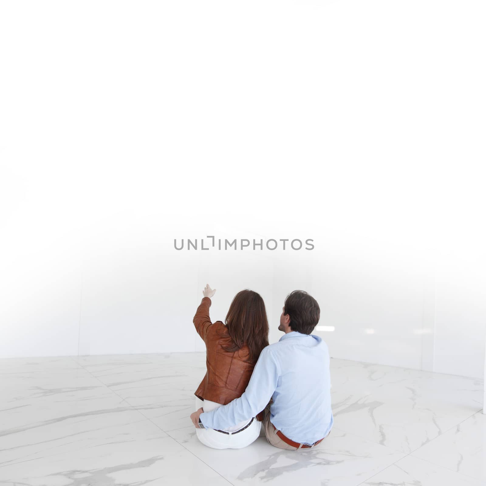 Couple sitting at their new empty apartment