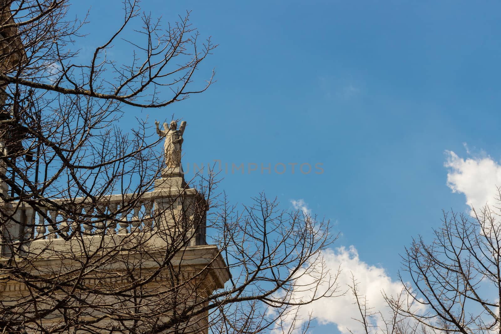 The detail of statue church in an italian sky