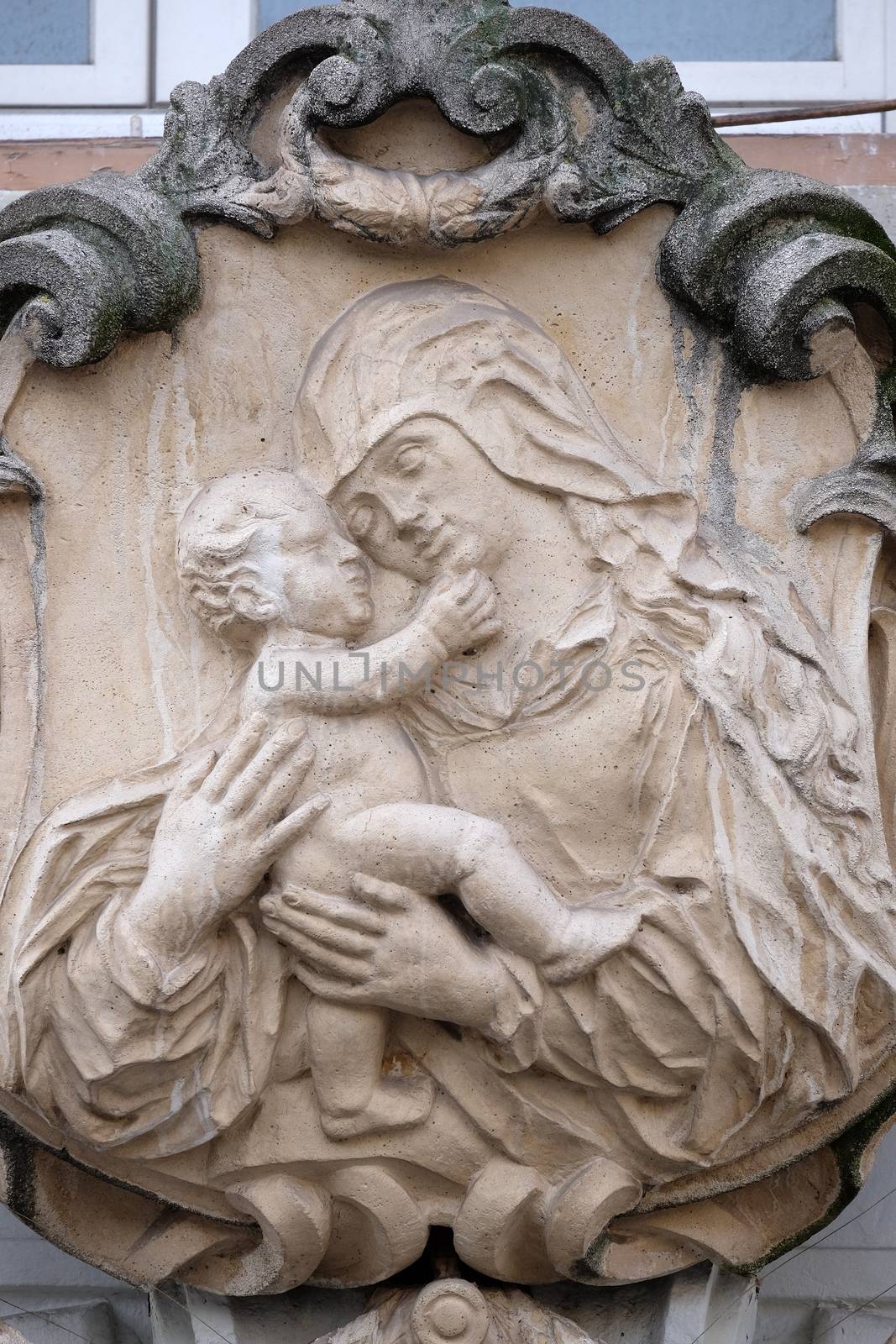 Virgin Mary with baby Jesus, statue on the house facade in Graz, Styria, Austria