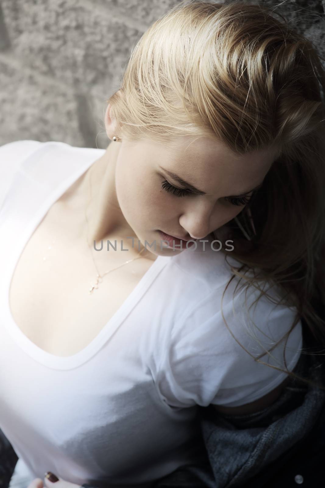 Urban style portrait of young beautiful blond woman in denim