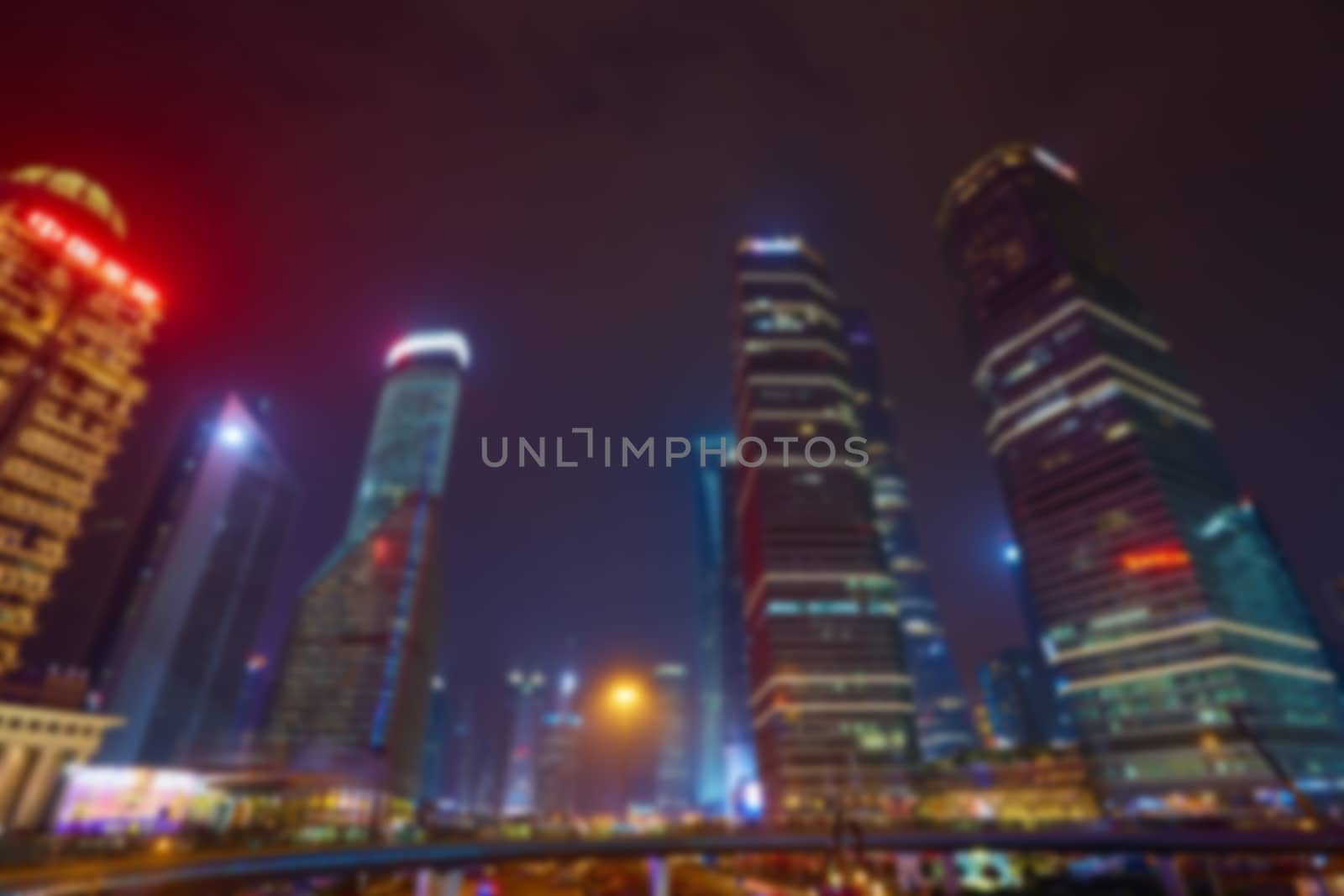 Shanghai skyline at night out of focus.  by sarymsakov