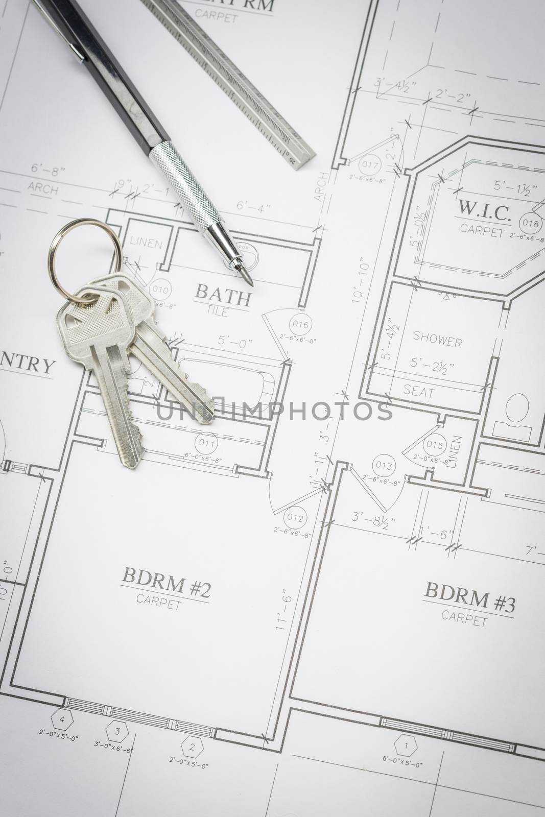 Engineer Pencil, Ruler and Keys Resting On Custom House Plans.