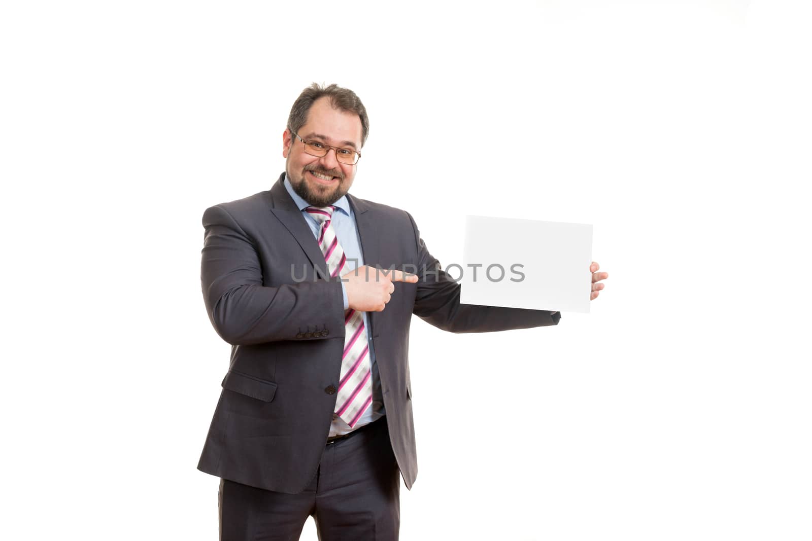 the adult man holds a sheet of paper in hand