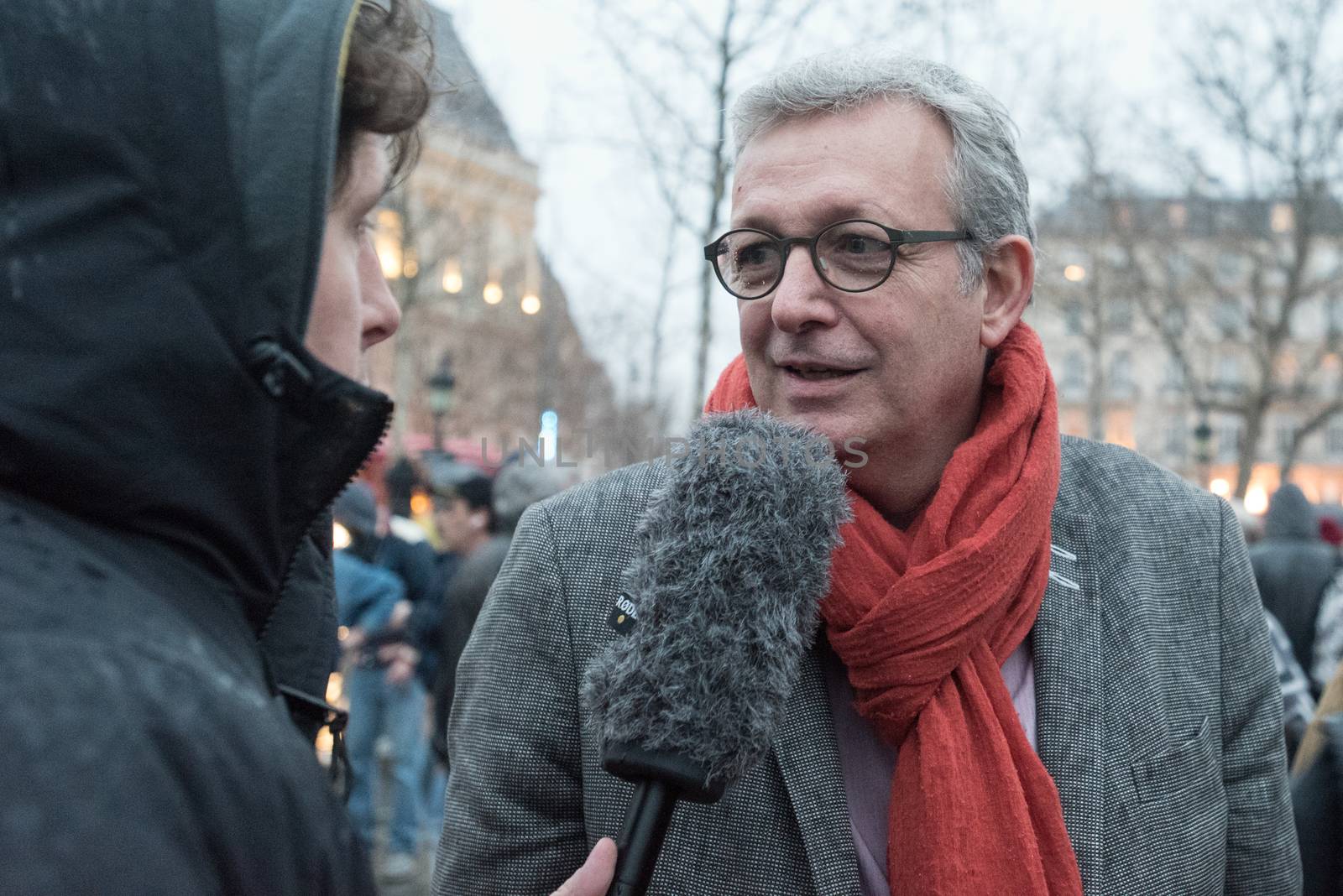 FRANCE, Paris : French Communist Party (PCF) General Secretary and Party of the European Left (EL) president Pierre Laurent (R) speaks to French Europe Ecologie Les Verts (EELV) green party spokesman Julien Bayou (L) as people join the Nuit Debout or Standing night movement at the Place de la Republique in Paris on April 2, 2016. A few hundred people rallied to demand the halt of home evictions which can begin the day after the end of the French winter break, after which tenants can be evicted from their homes. They also gathered to show their opposition to the labor reform law in the wake of the nationwide demonstration which took place on March 31, 2016.