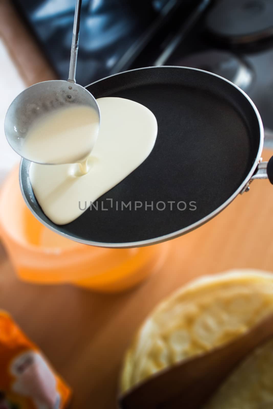 Pouring pancake liquid on frying pan