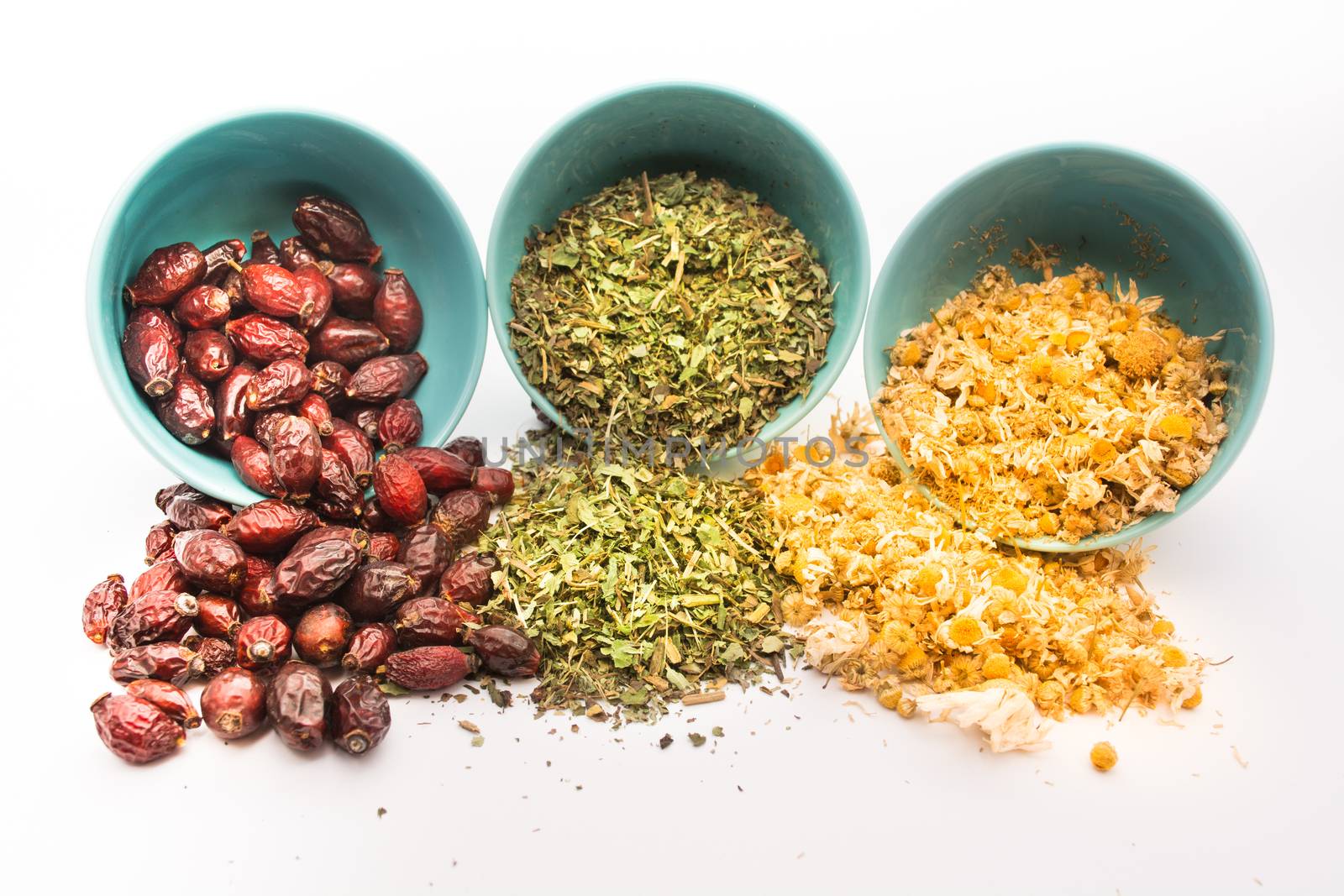 Spilled tea herb in bowls on white background