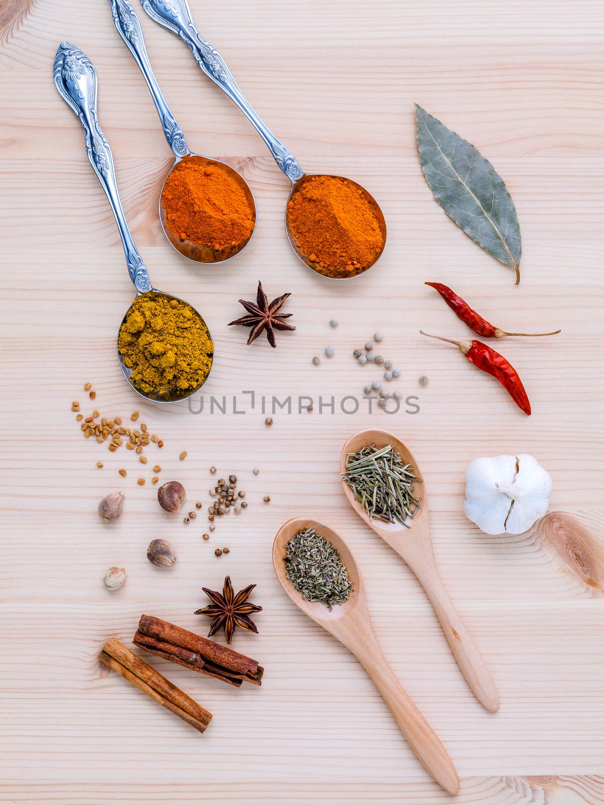 Assorted of dried spices white pepper,cumin ,bay leaf,cinnamon,star anise,thyme,ginger ,chili ,garlic  and rosemary on wooden background.