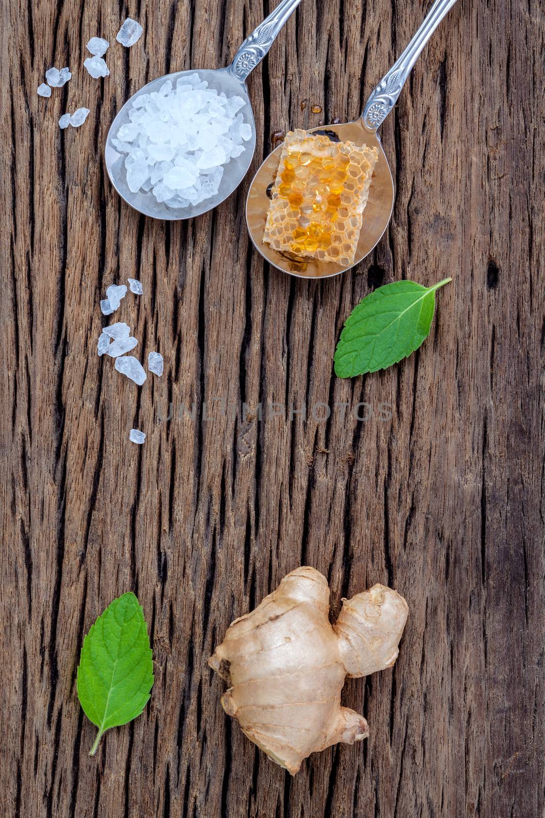 The ingredients of ginger tea with ginger roots , ginger powder , honey and peppermint on rustic wooden table.