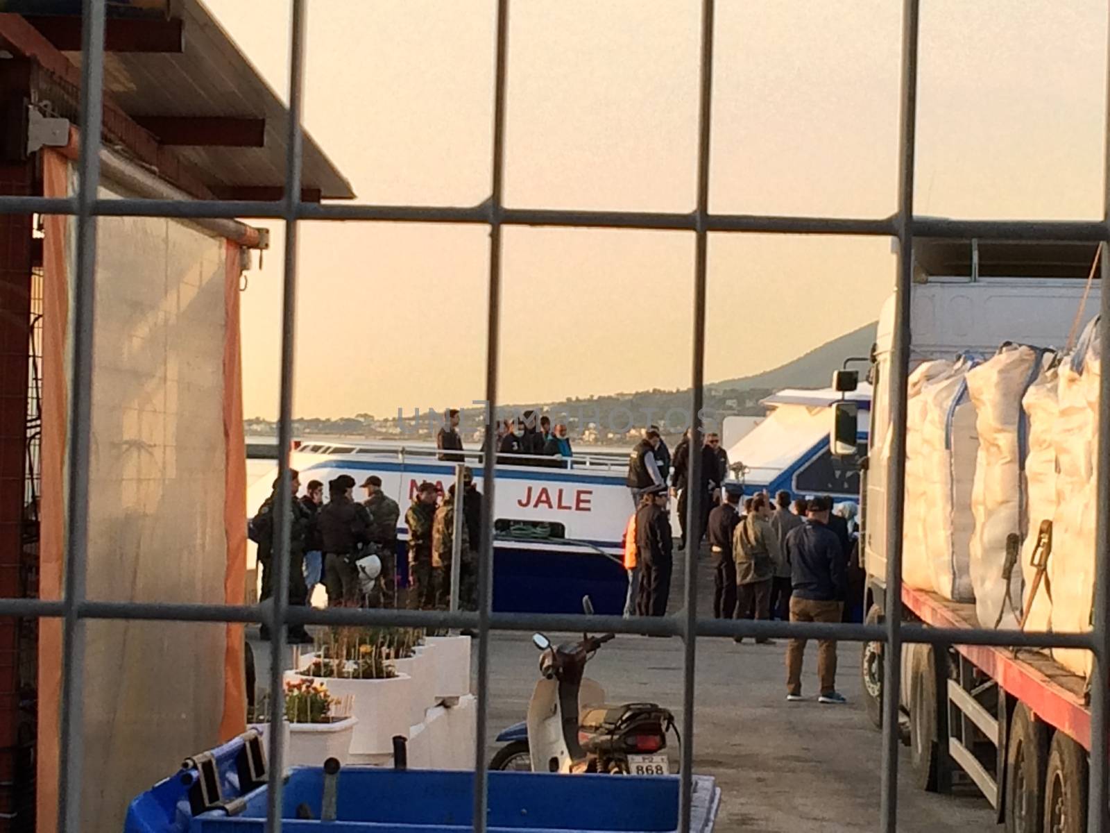 GREECE, Lesvos: The first migrants are boarded the boat under police presence in Lesvos as Greece sent a first wave of migrants back to Dikili, Turkey on April 4, 2016 under an EU deal that has faced heavy criticism from rights groups. Under the agreement, designed to halt the main influx which comes from Turkey, all irregular migrants arriving since March 20 face being sent back, although the deal calls for each case to be examined individually. For every Syrian refugee returned, another Syrian refugee will be resettled from Turkey to the EU, with numbers capped at 72,000.