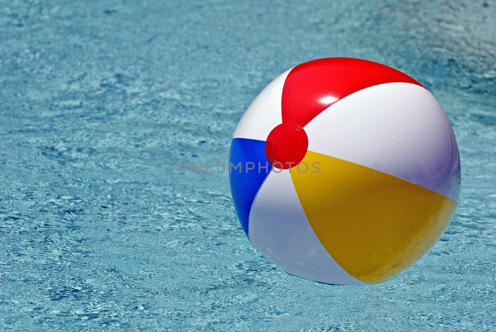 Colorful Beach Ball In Swimming Pool by stockbuster1