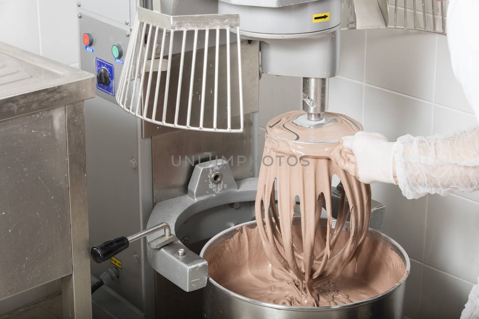 chef is preparing cake mix in industrial bread mixer- kneading machine