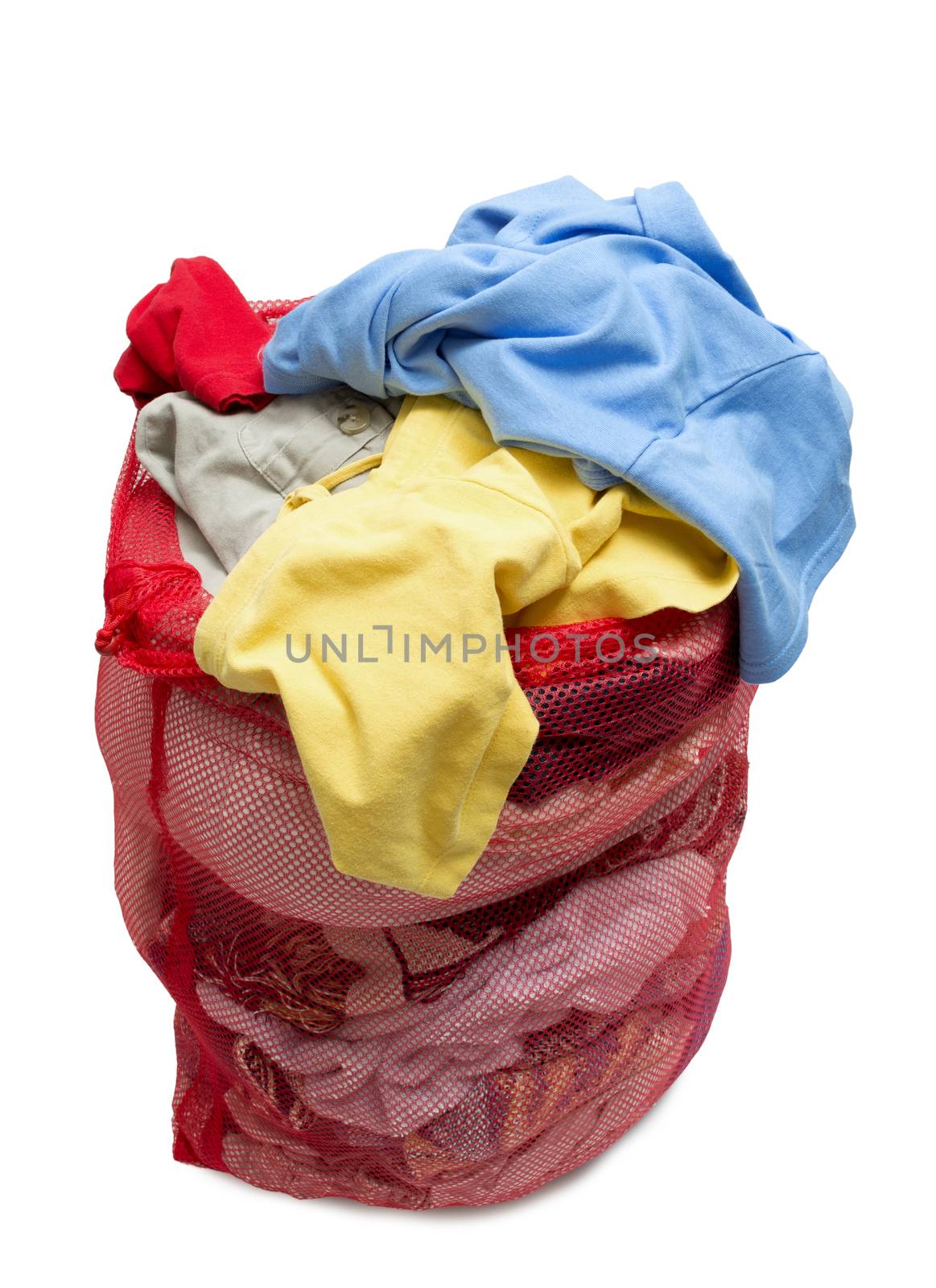 Vertical shot of a bunch of colorful and messy clothes in a red mesh laundry bag.  Isolated on white background